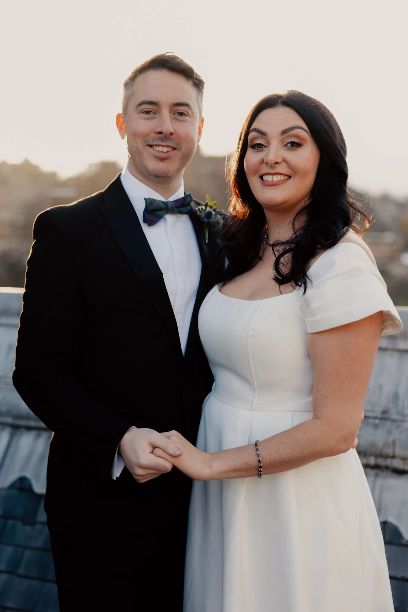 Milly and Vincent standing together in wedding dress and tuxedo.