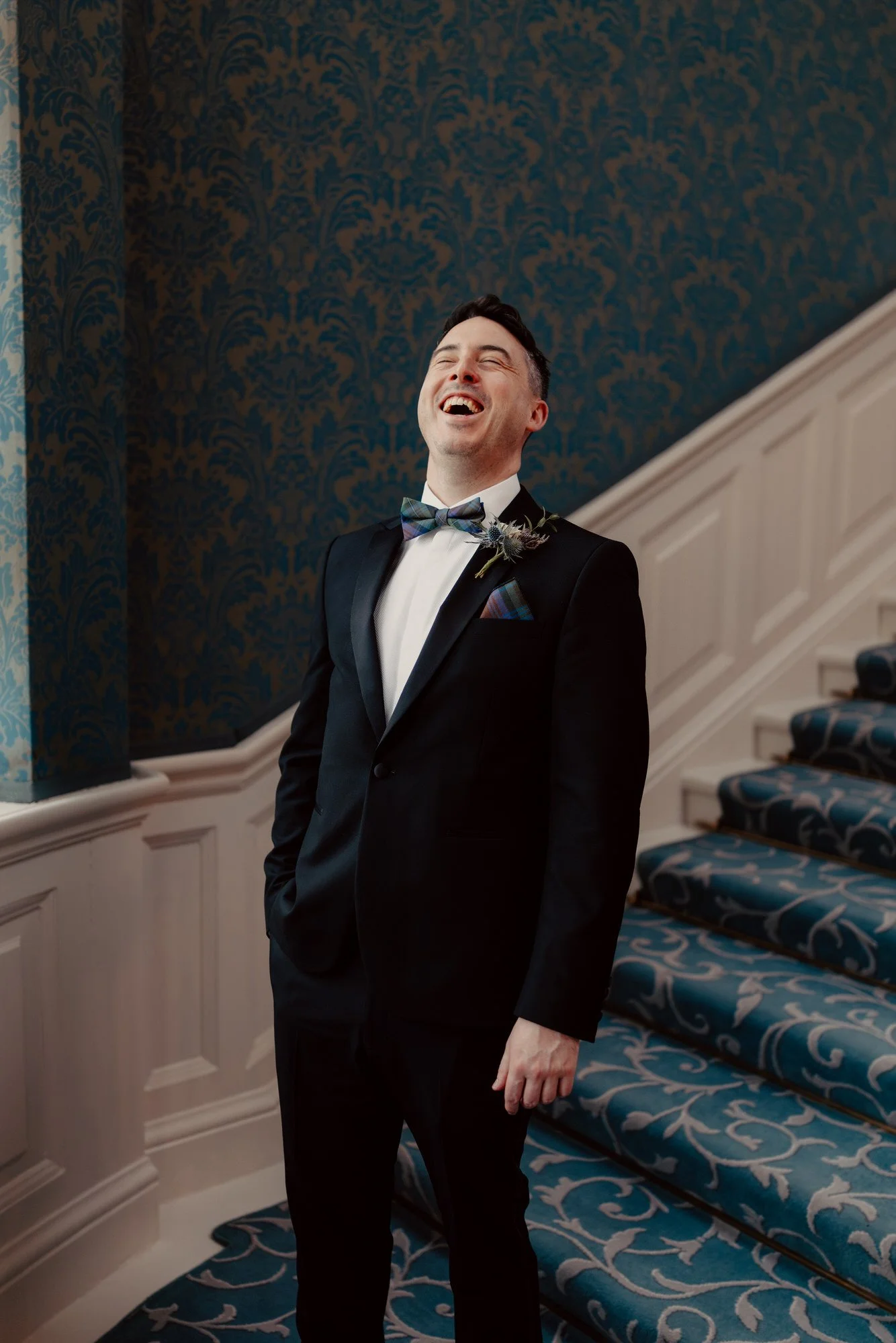 Vincent smiling on the hotel staircase.