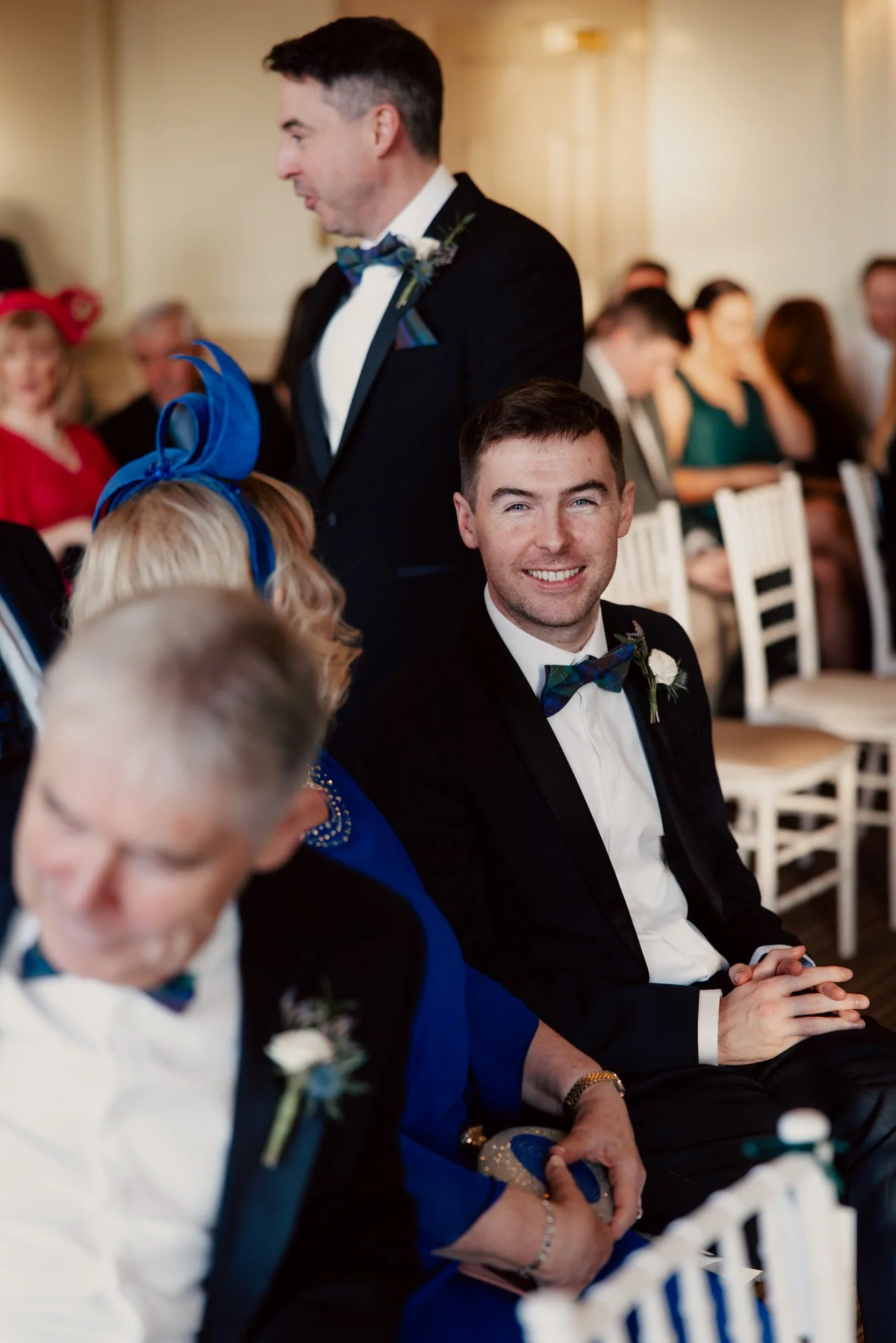 Vincent smiling among friends and family in the ceremony room.