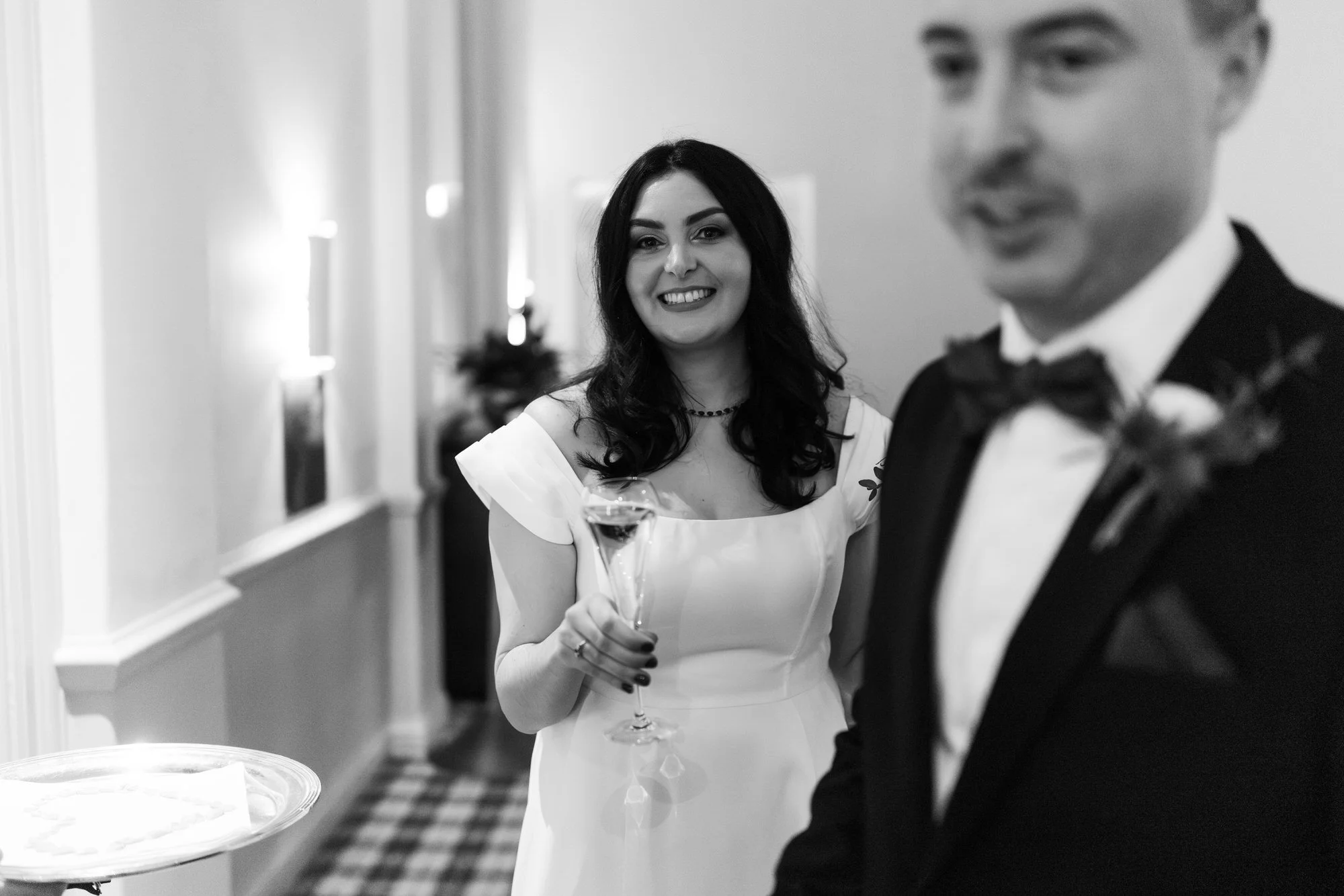 Black-and-white close-up of Milly smiling beside Vincent.