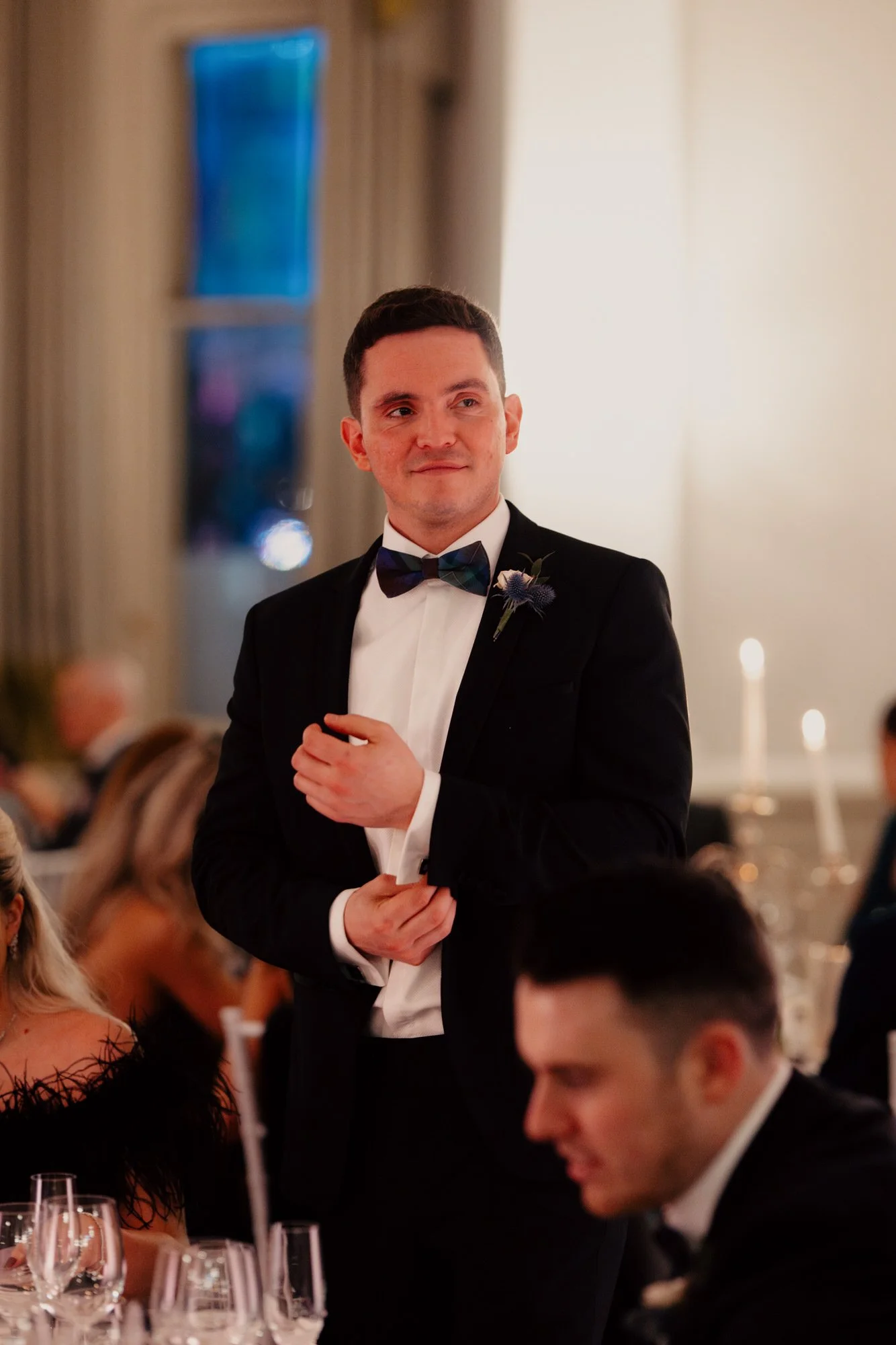 Vincent standing with a champagne glass at the wedding breakfast.