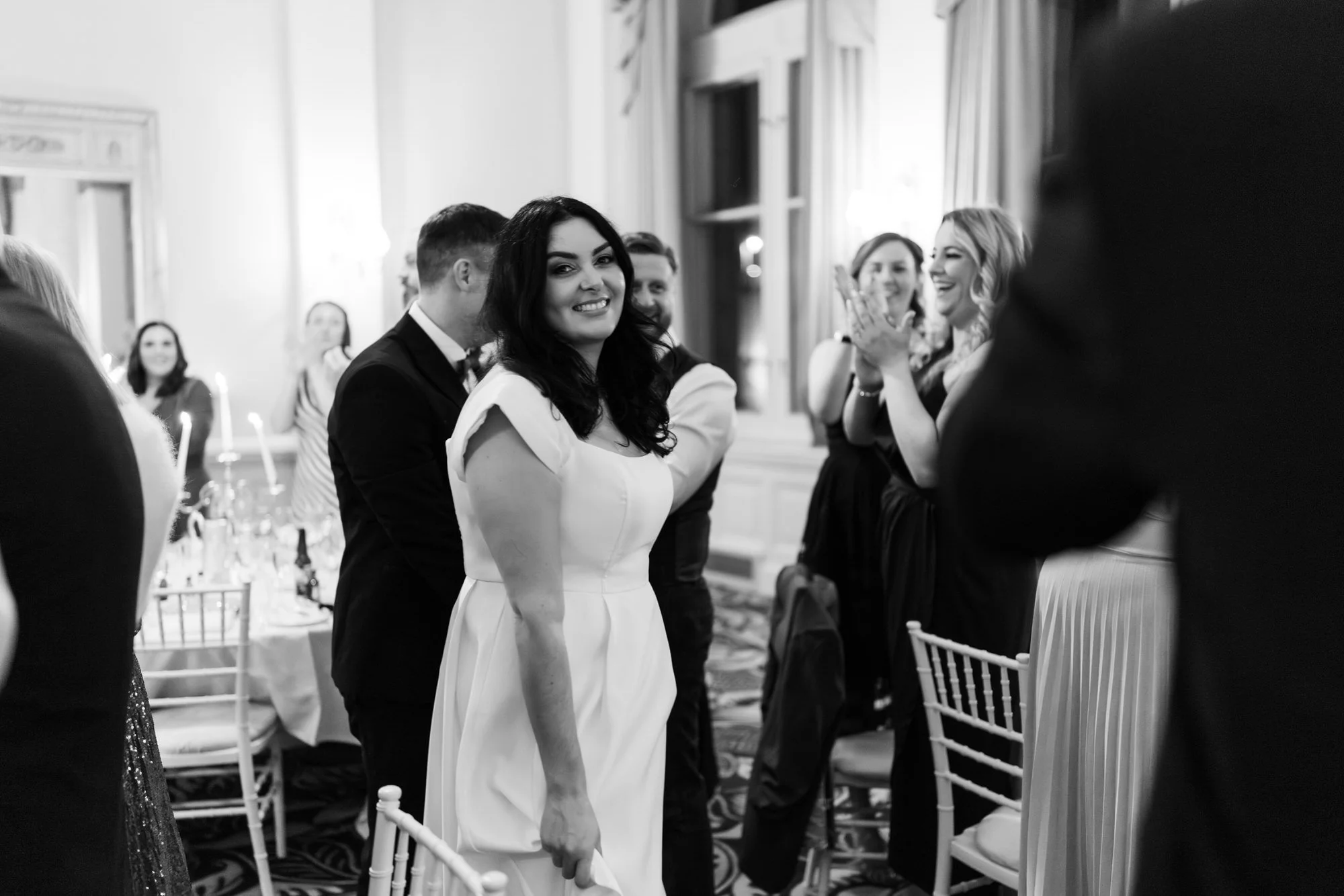 Milly waving as guests welcome the newlyweds.