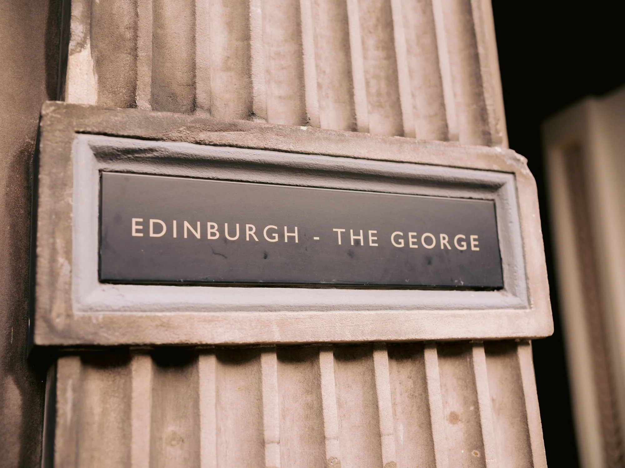 Stone sign at the entrance to The George Hotel in Edinburgh