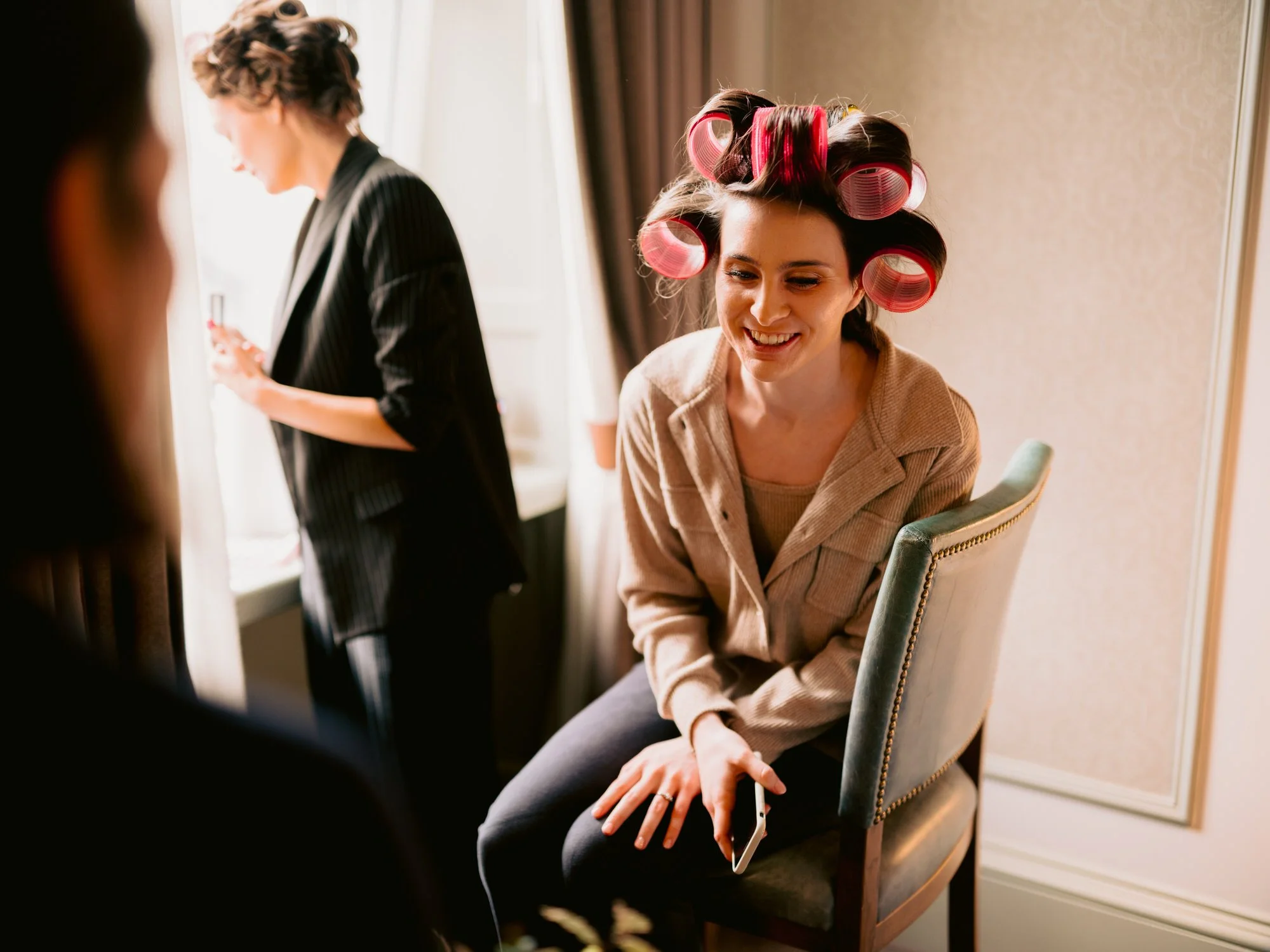 Nicola laughing with hair rollers in during bridal preparations