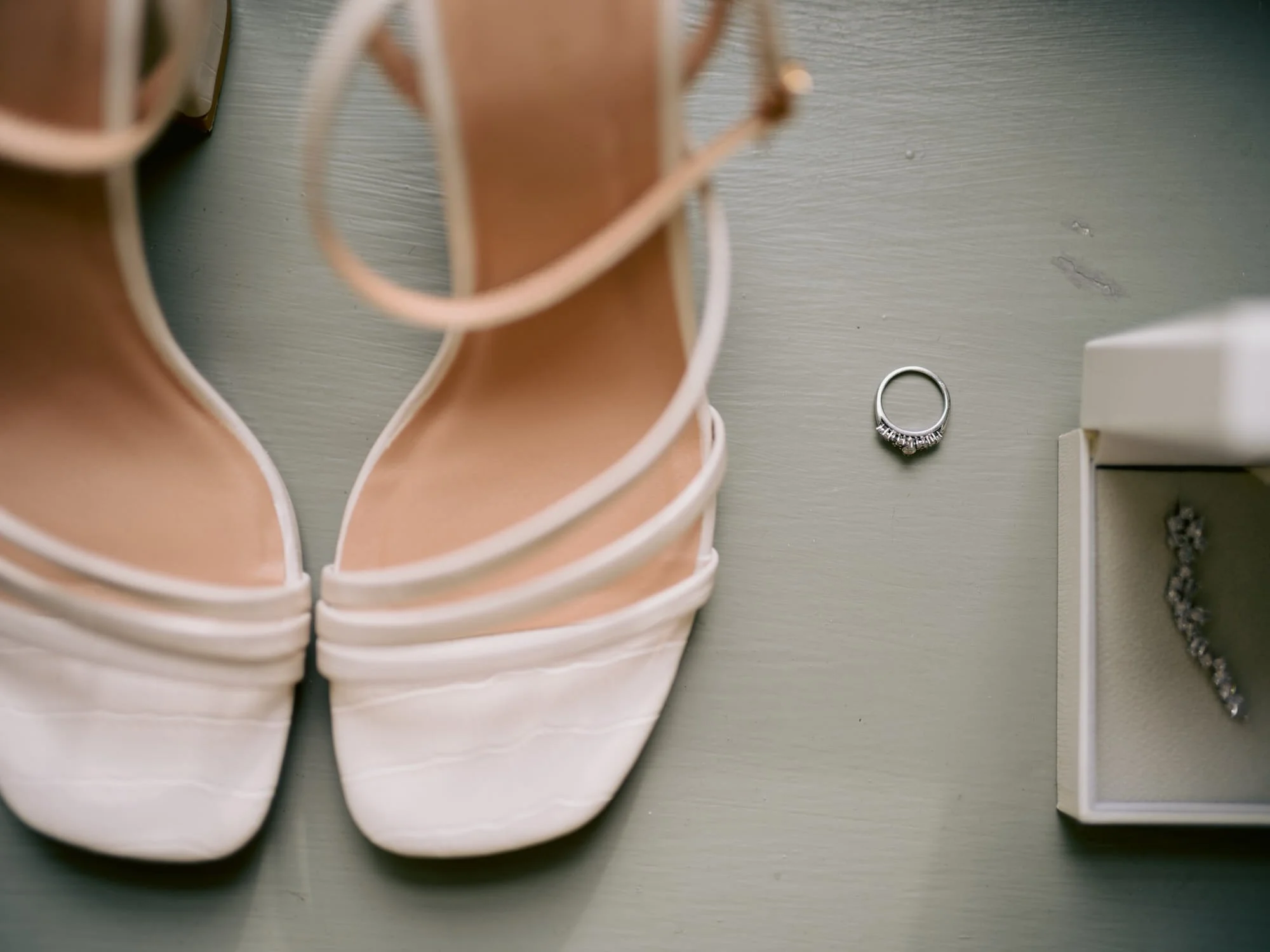 Bridal shoes and a ring laid out during preparations