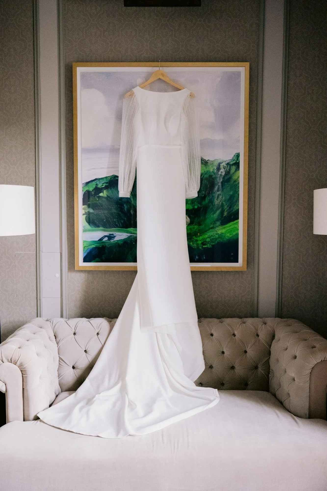 Nicola’s white wedding dress hanging above a sofa
