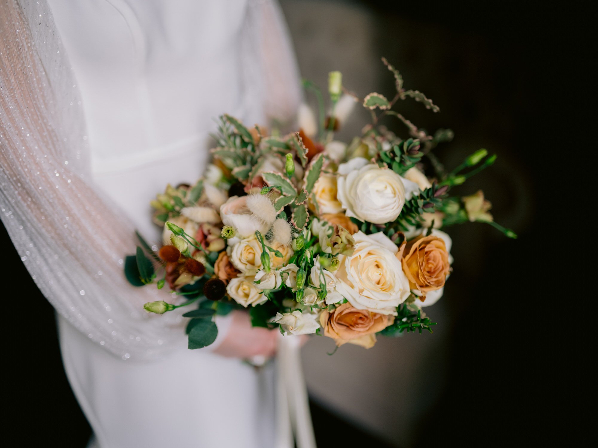 Nicola holding her peach and cream bridal bouquet
