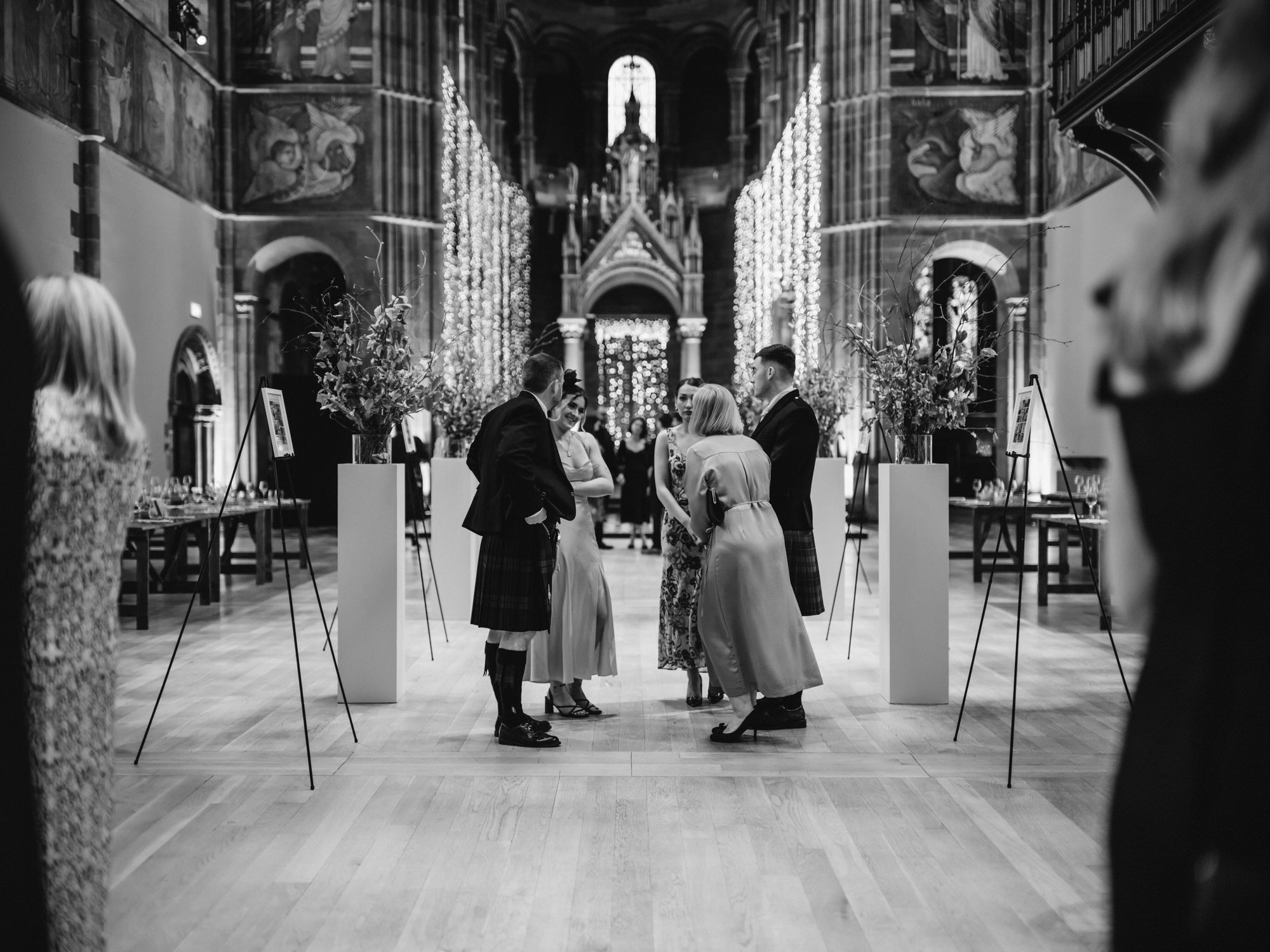 Guests gathering beneath the murals at Mansfield Traquair