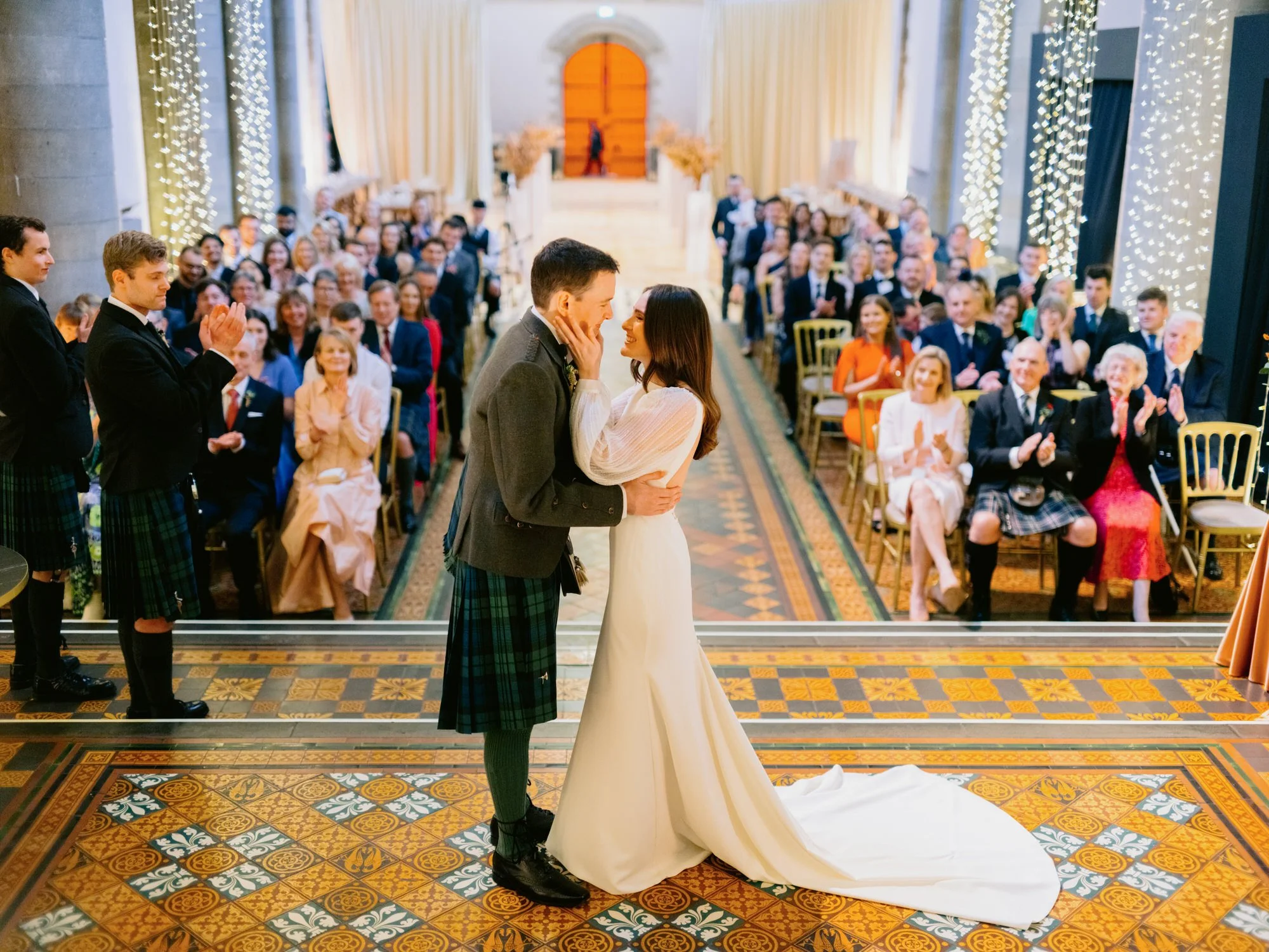 Nicola and Fraser kissing at the end of their ceremony