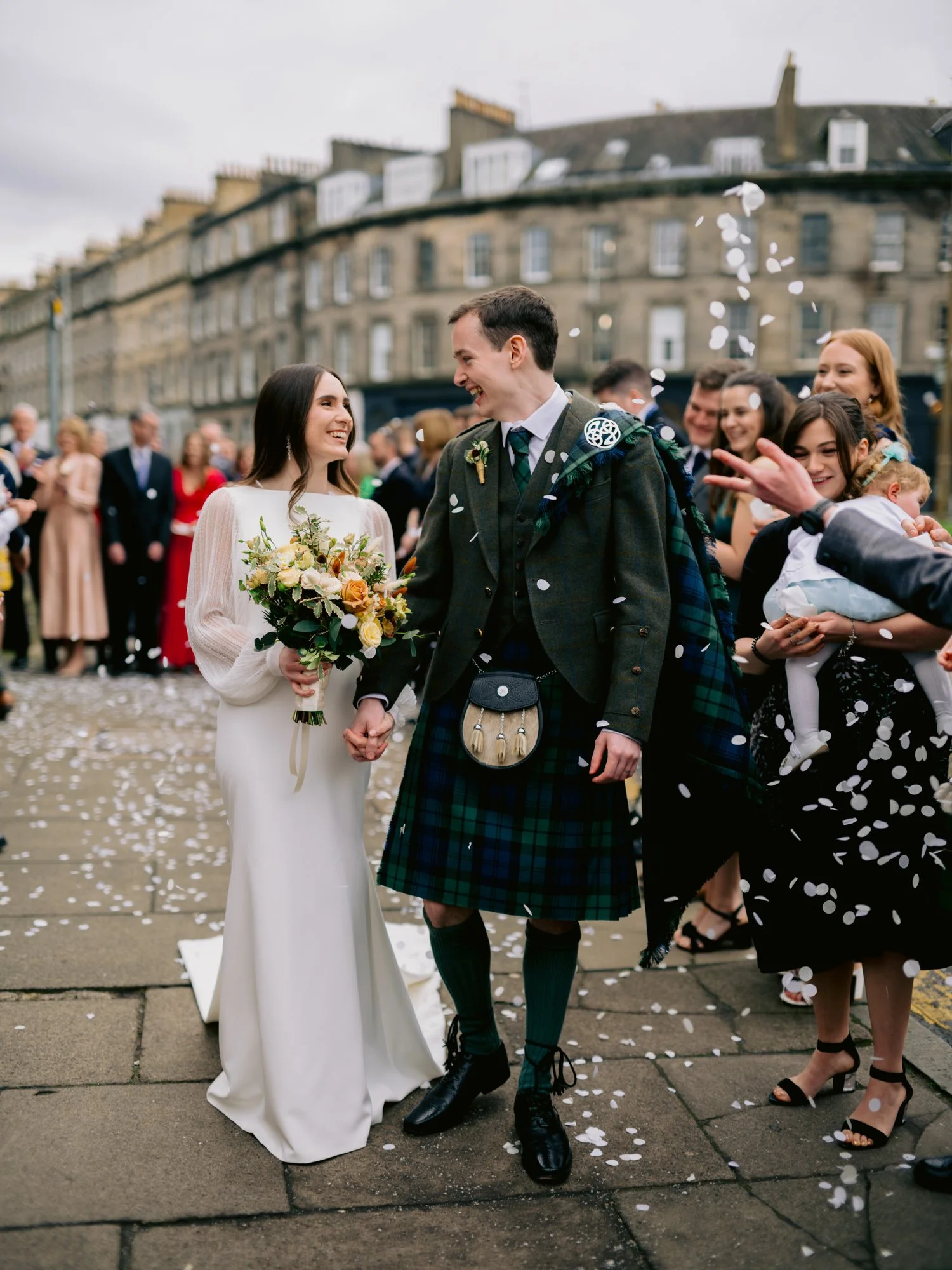 Guests throwing confetti outside Mansfield Traquair