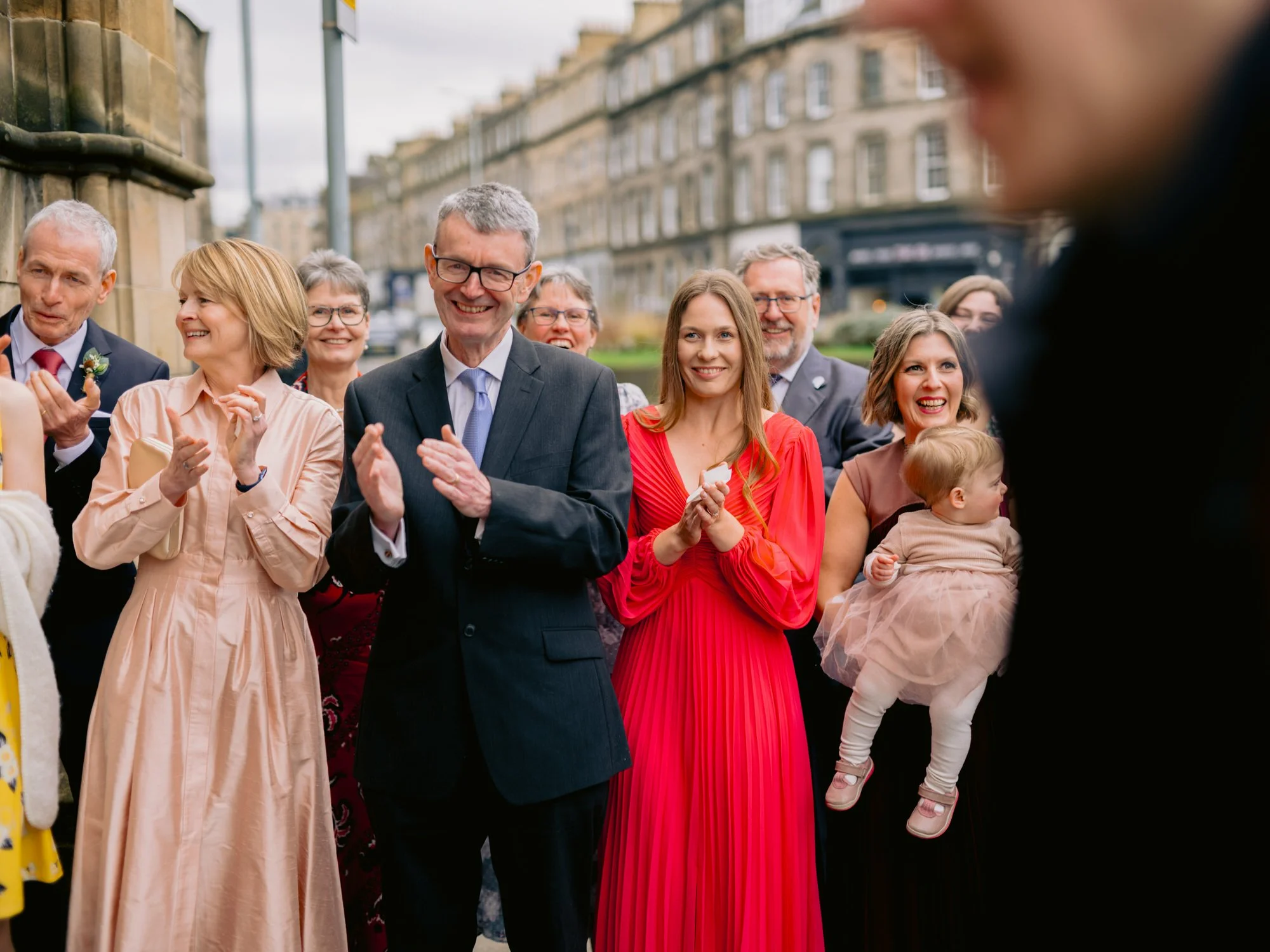 Wedding guests applauding outside the venue