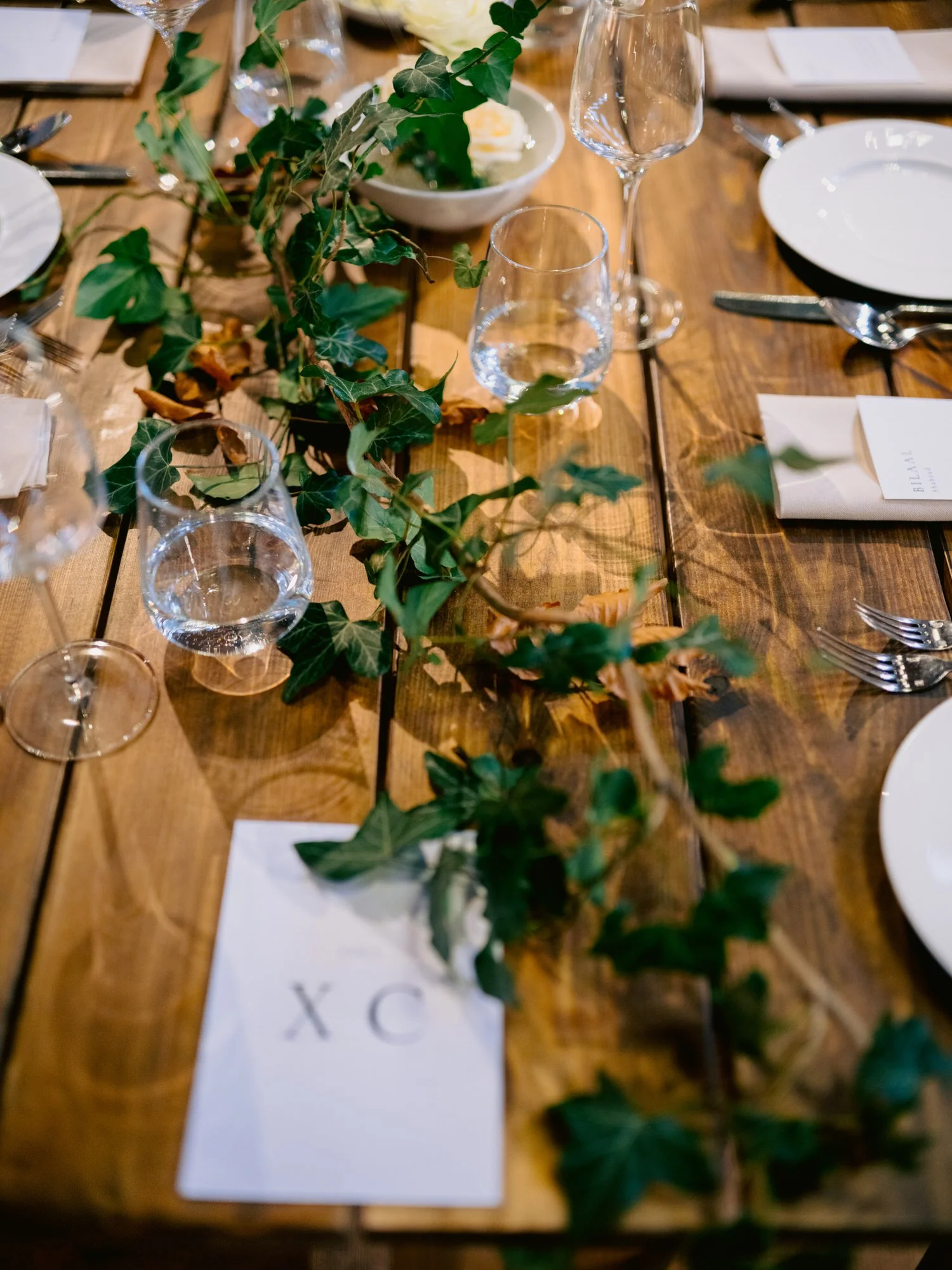 Greenery and place cards on the wedding dining table