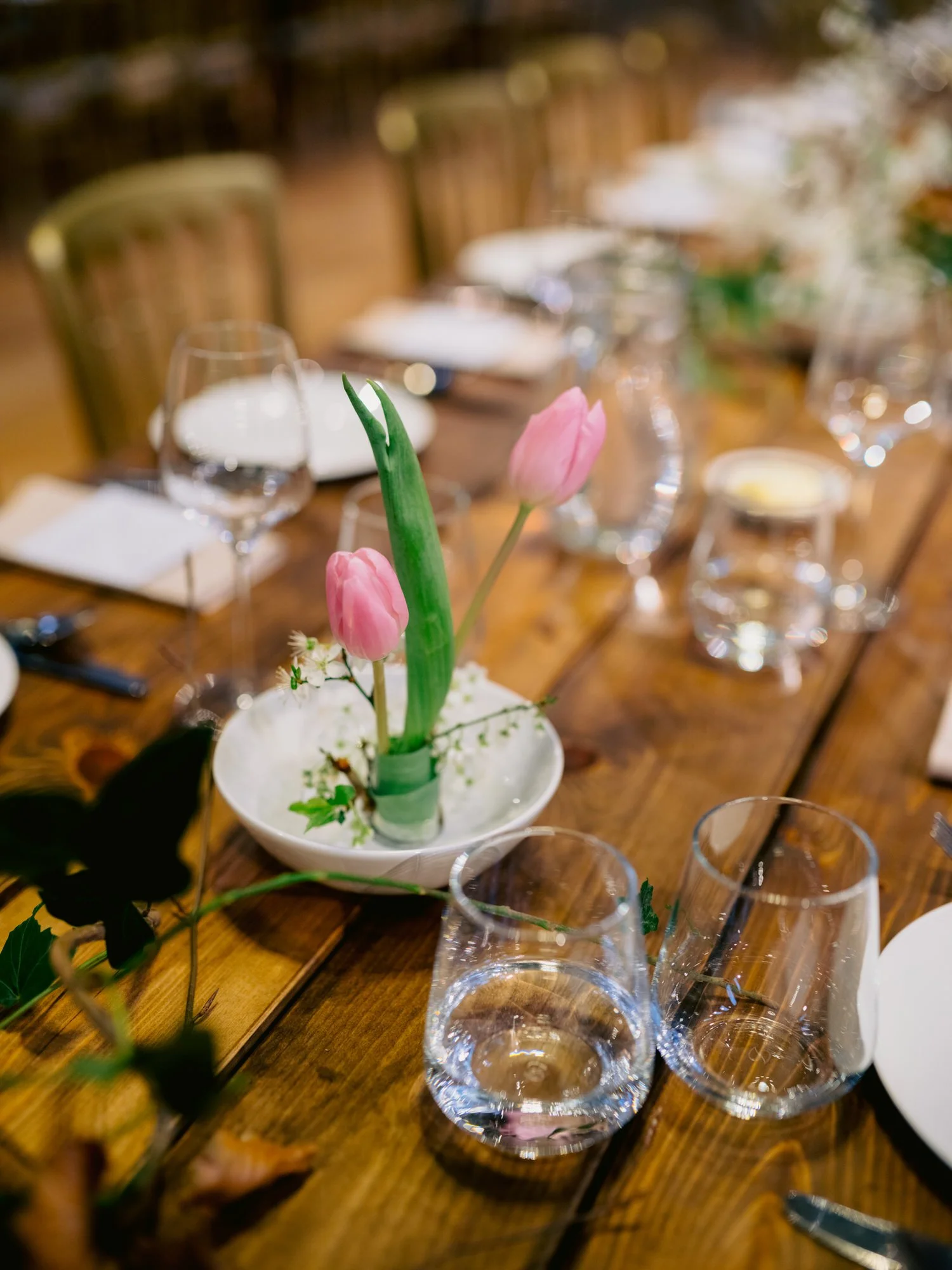 Green candle and glasses on the wedding breakfast table