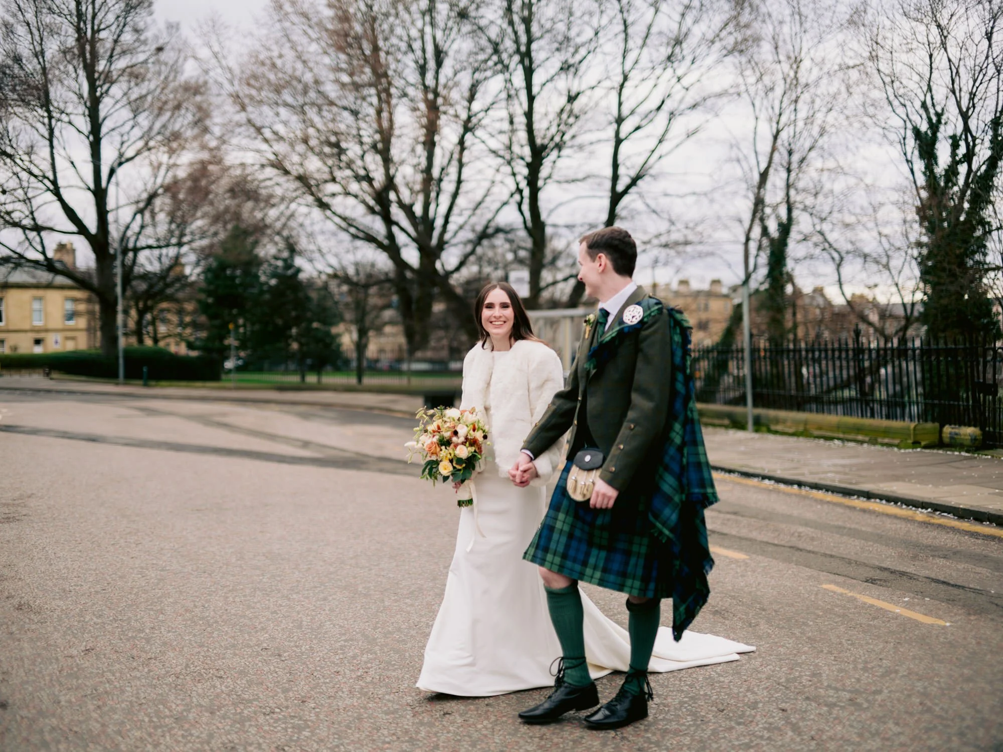 The newlyweds walking together on an Edinburgh street
