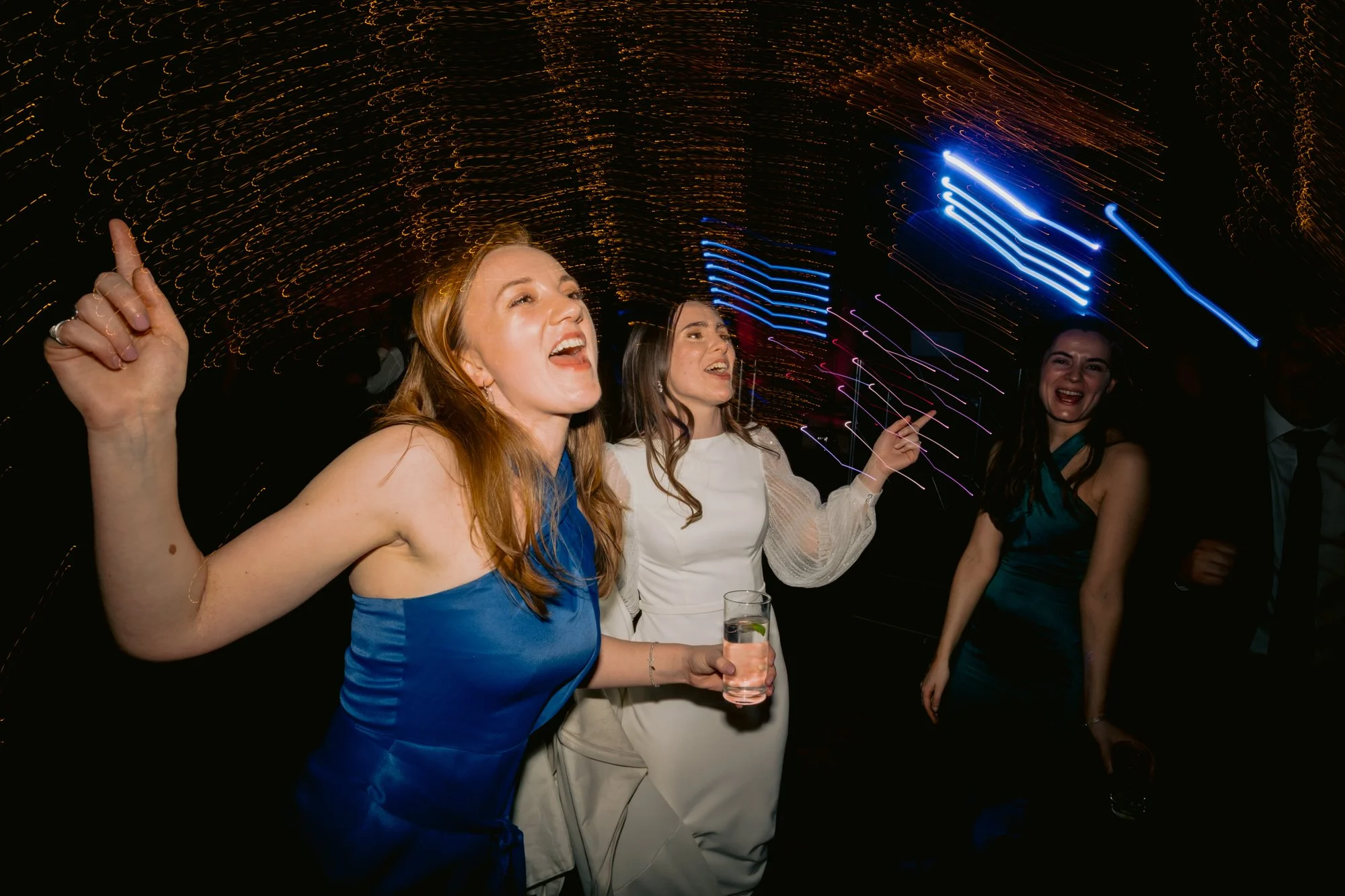 Guests laughing and singing on the dance floor