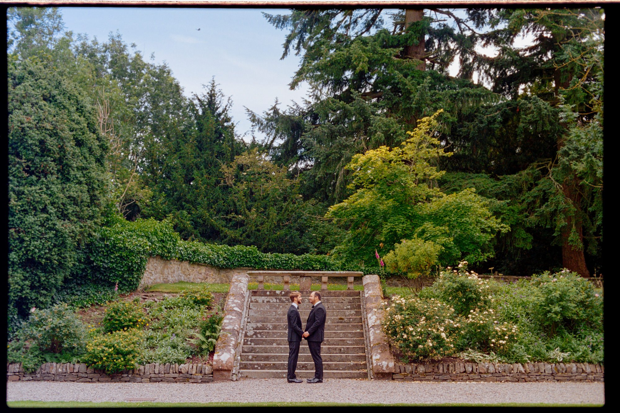 A wide view of the grooms standing at the foot of garden steps at Thirlestane Castle.