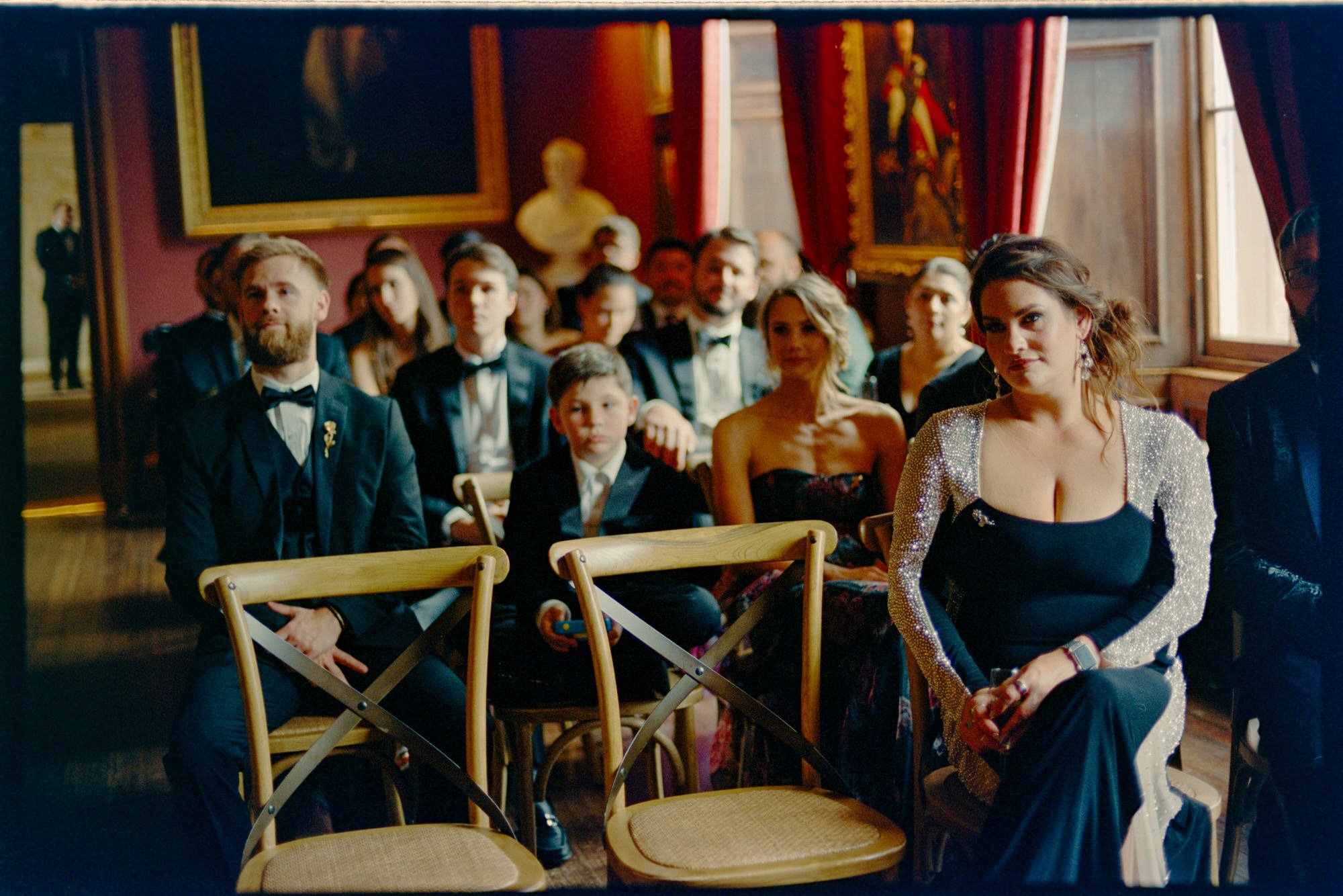 Guests taking their seats for the indoor castle wedding ceremony.
