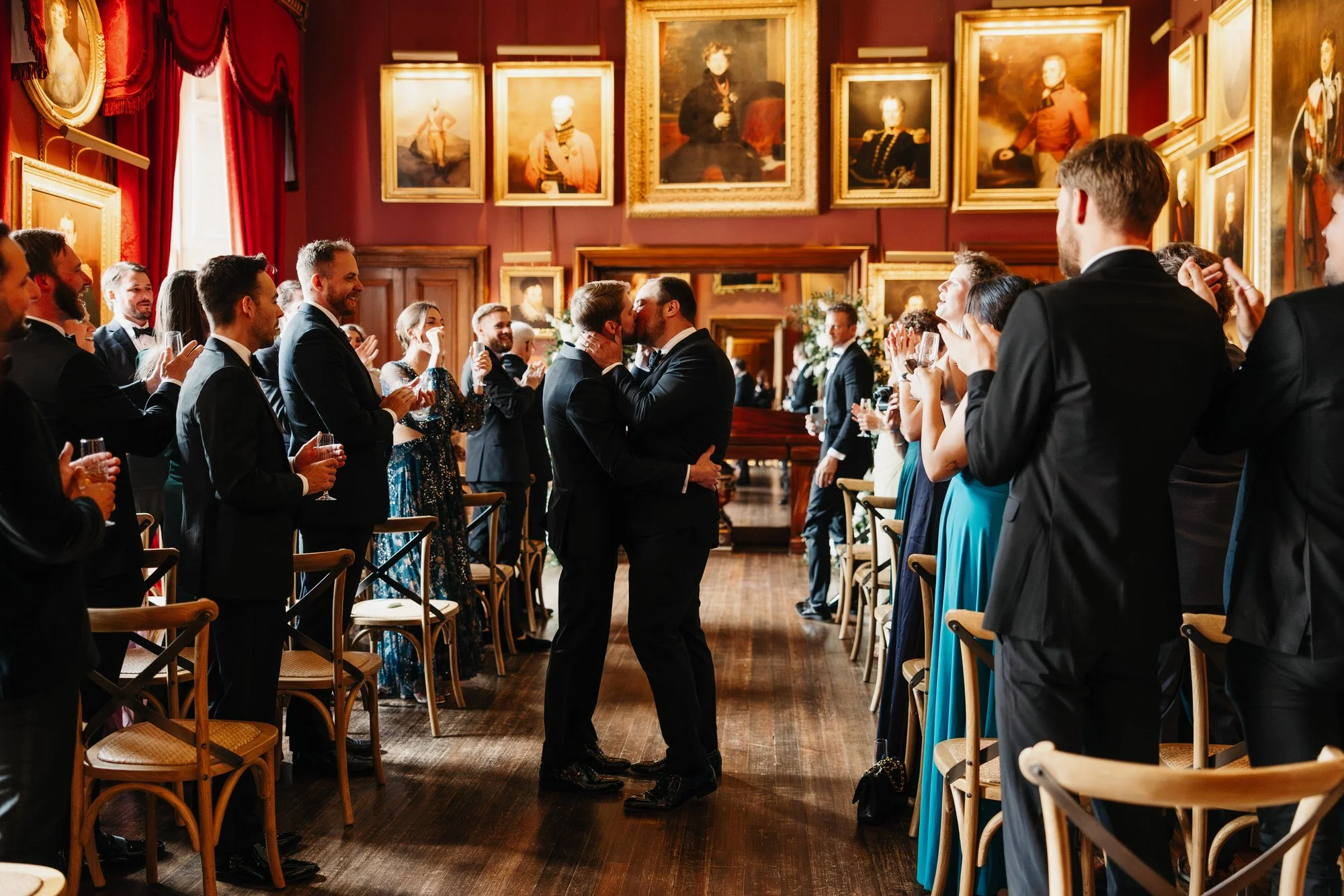 Guests applauding as the grooms enter the ceremony room.