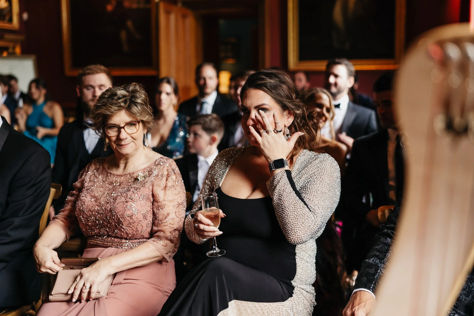 Guests smiling and wiping away tears during the ceremony.