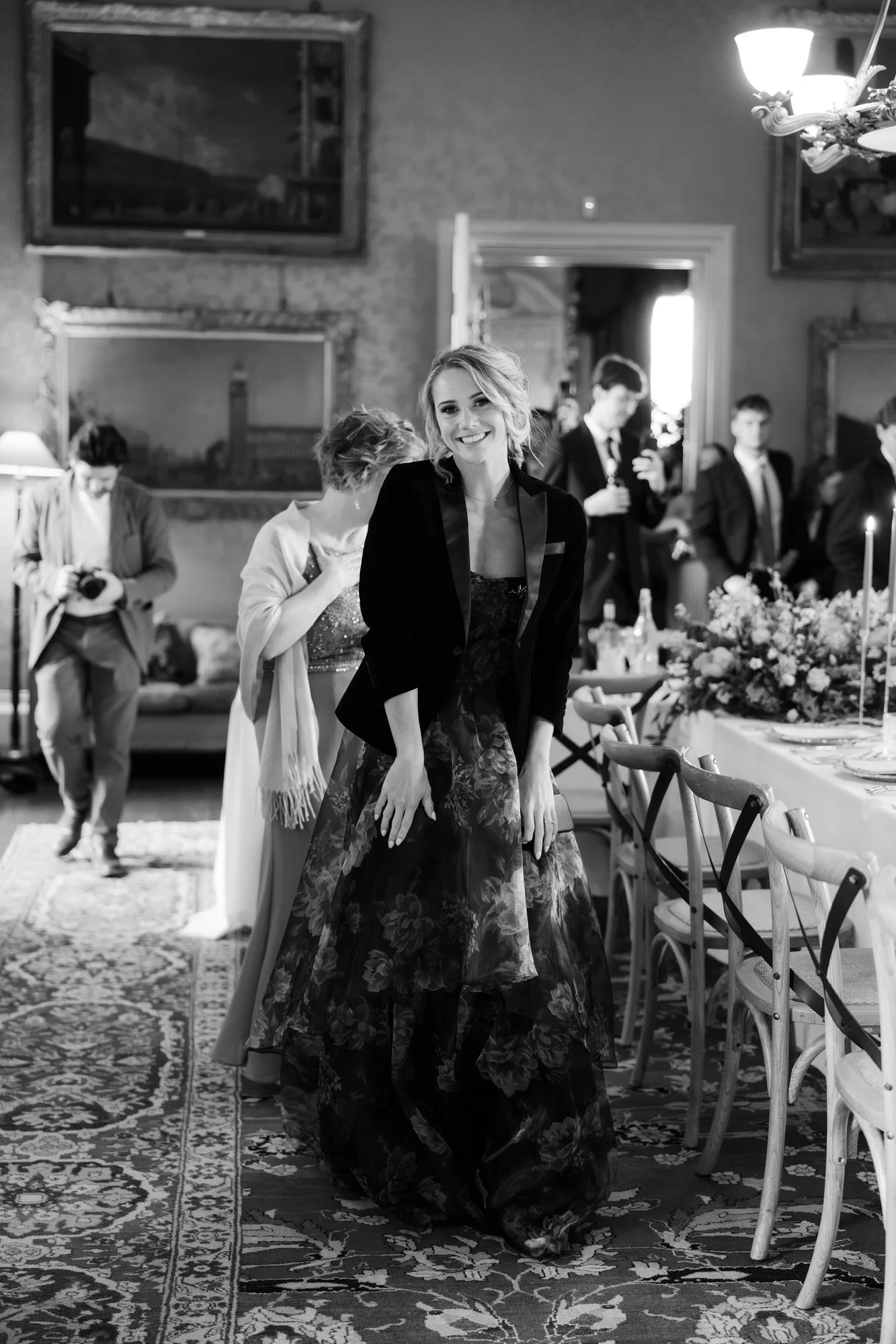Black-and-white photograph of a speaker standing beside the wedding table.