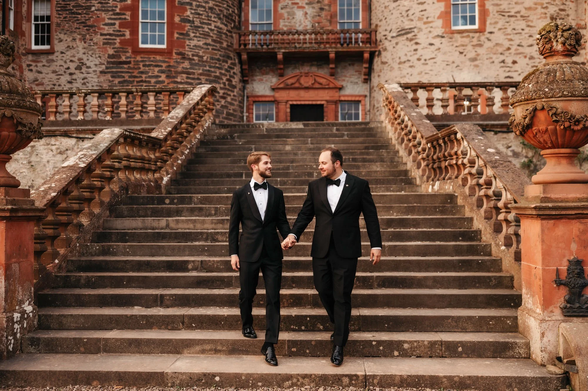 The newlyweds walking down Thirlestane Castle's broad front steps.