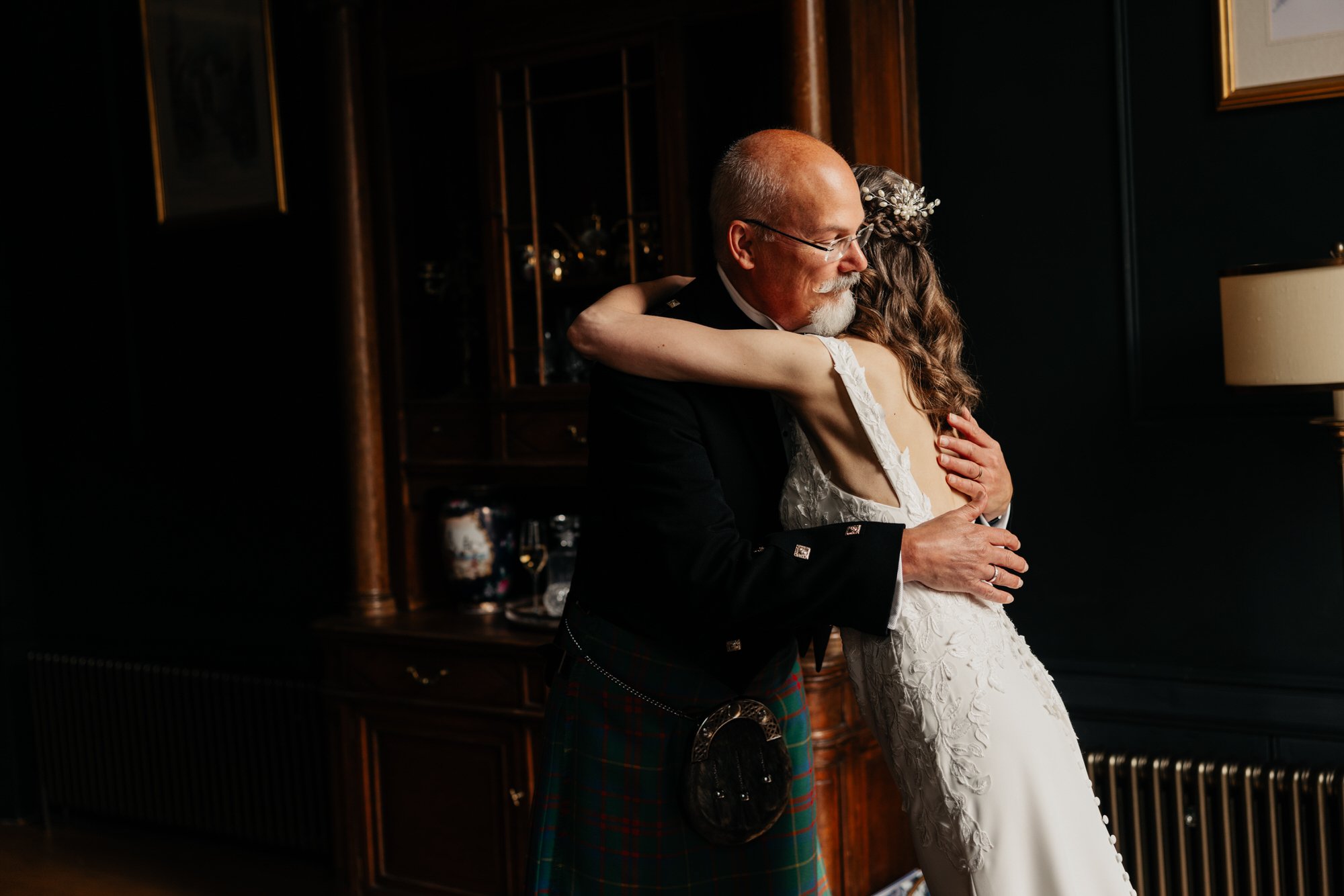 A bride embracing a family member before leaving