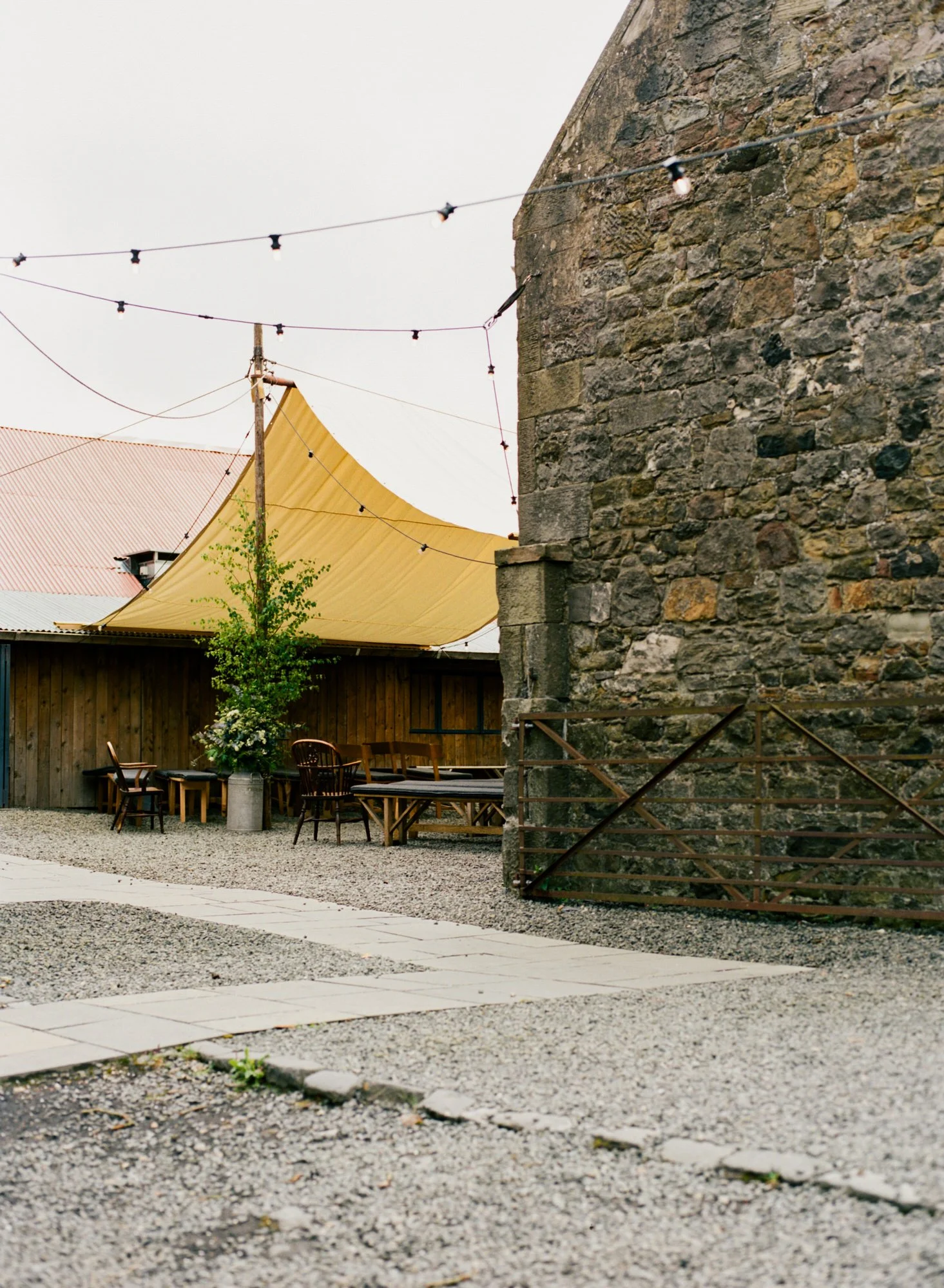The stone courtyard and ceremony canopy at The Free Company