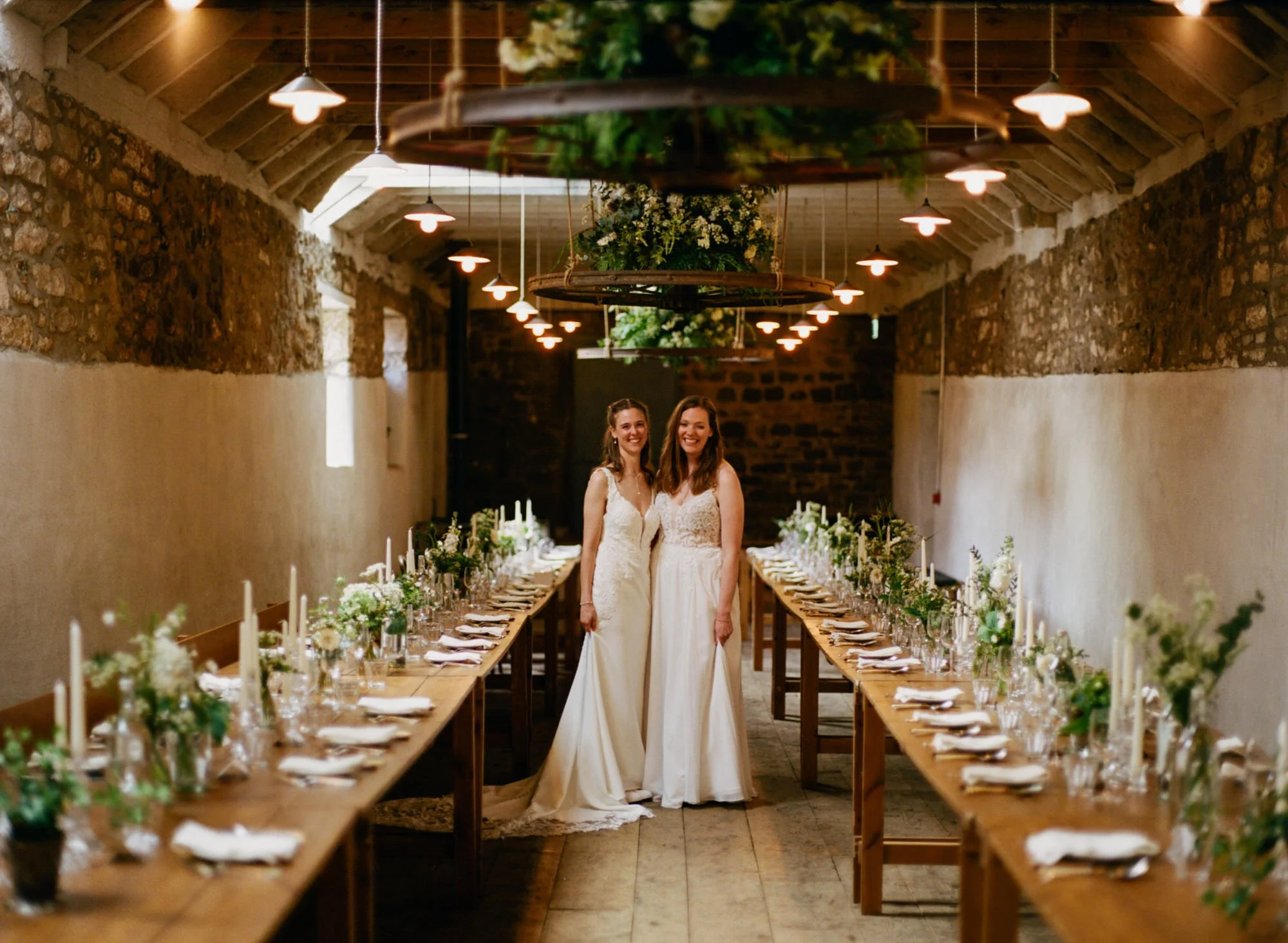Jackie and Briony standing between the long dinner tables