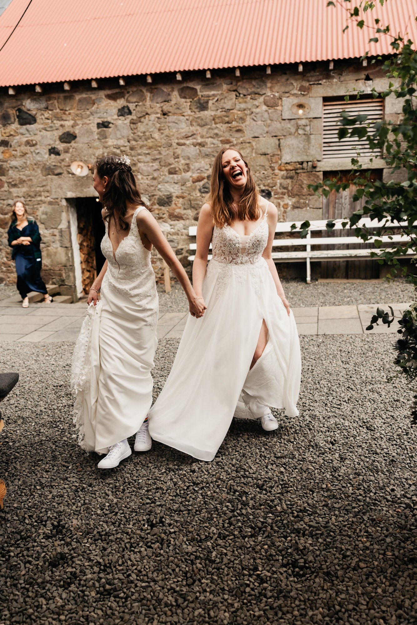 The brides walking across The Free Company courtyard