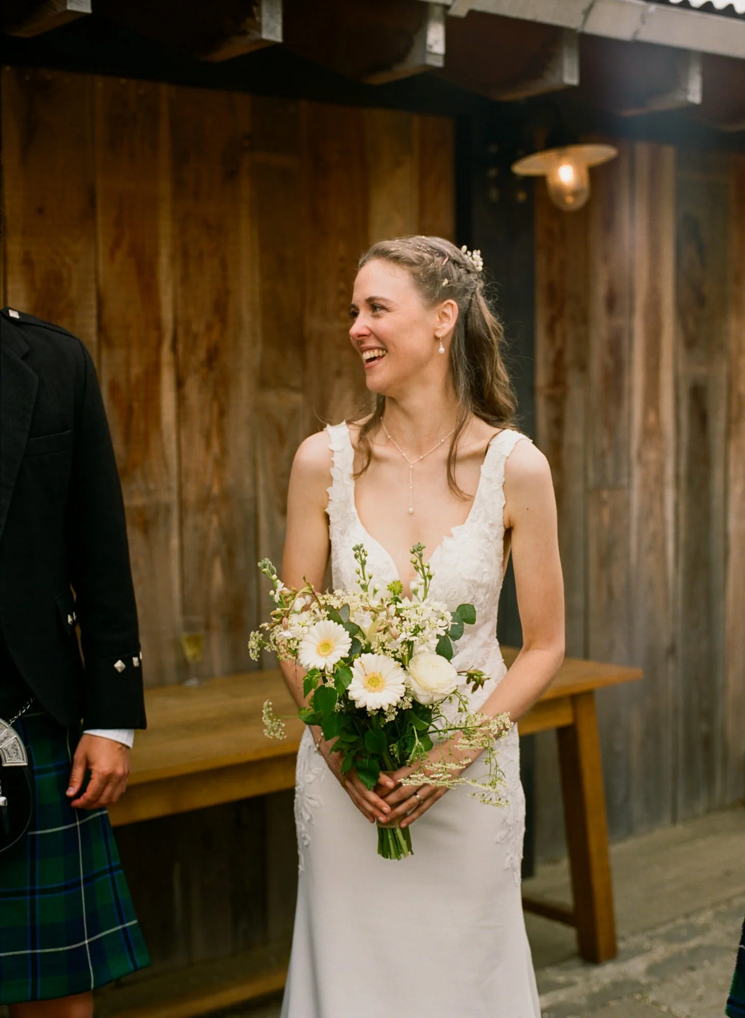 A bride carrying her bouquet through a doorway