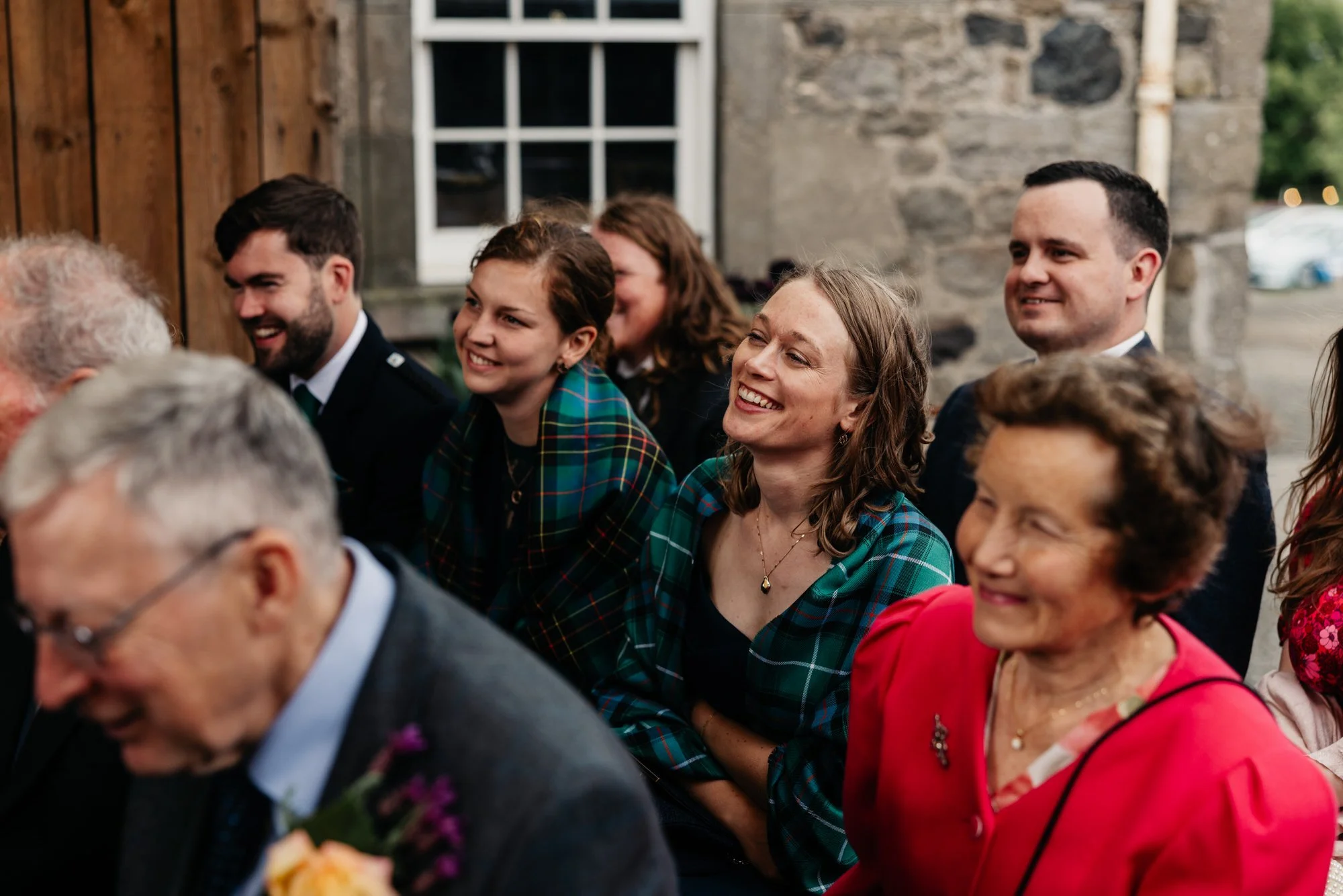 Guests smiling during the wedding ceremony