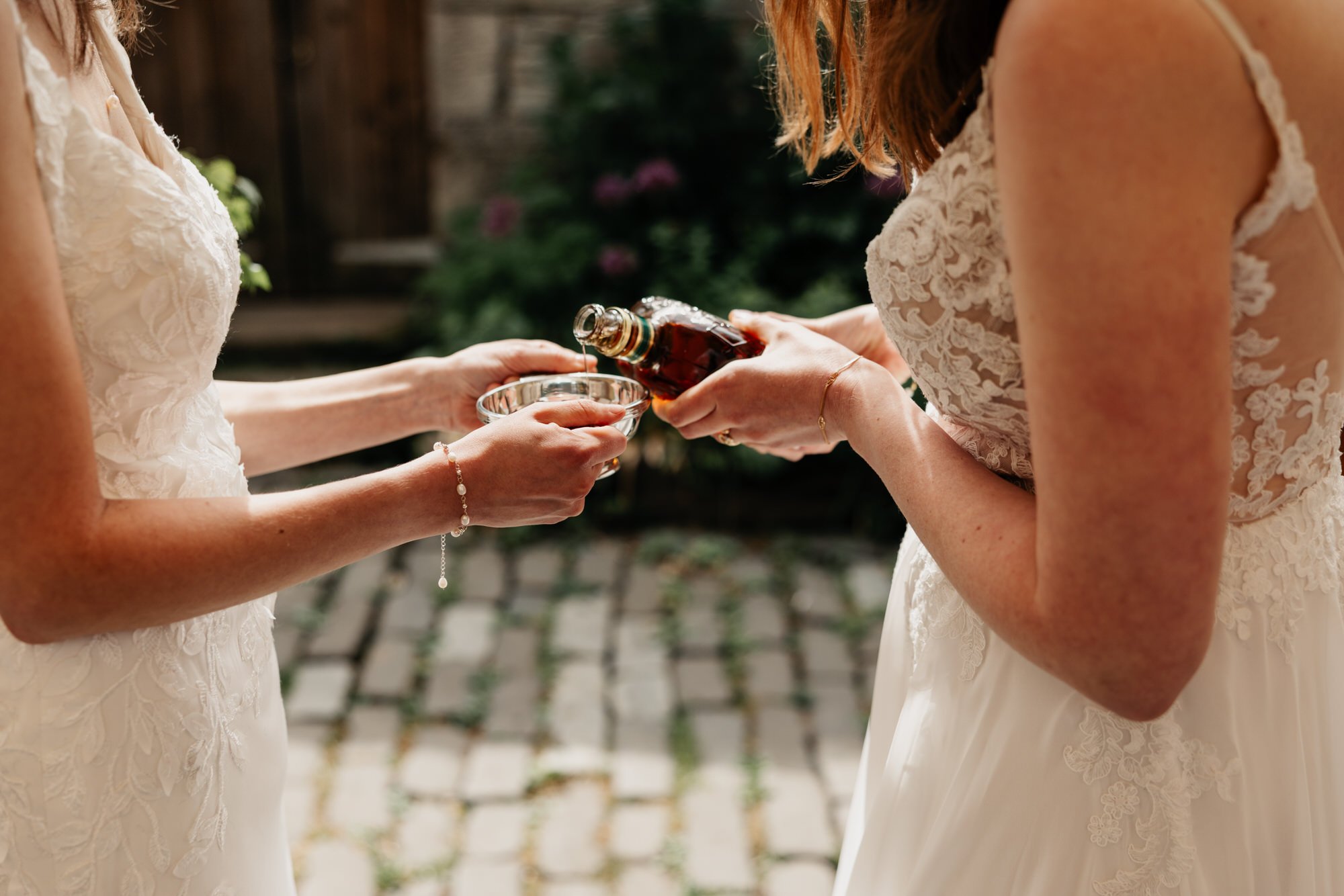 Hands holding the engraved wedding quaich