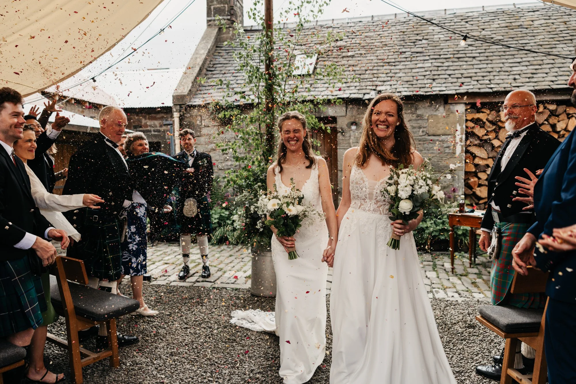 Jackie and Briony walking through a shower of confetti