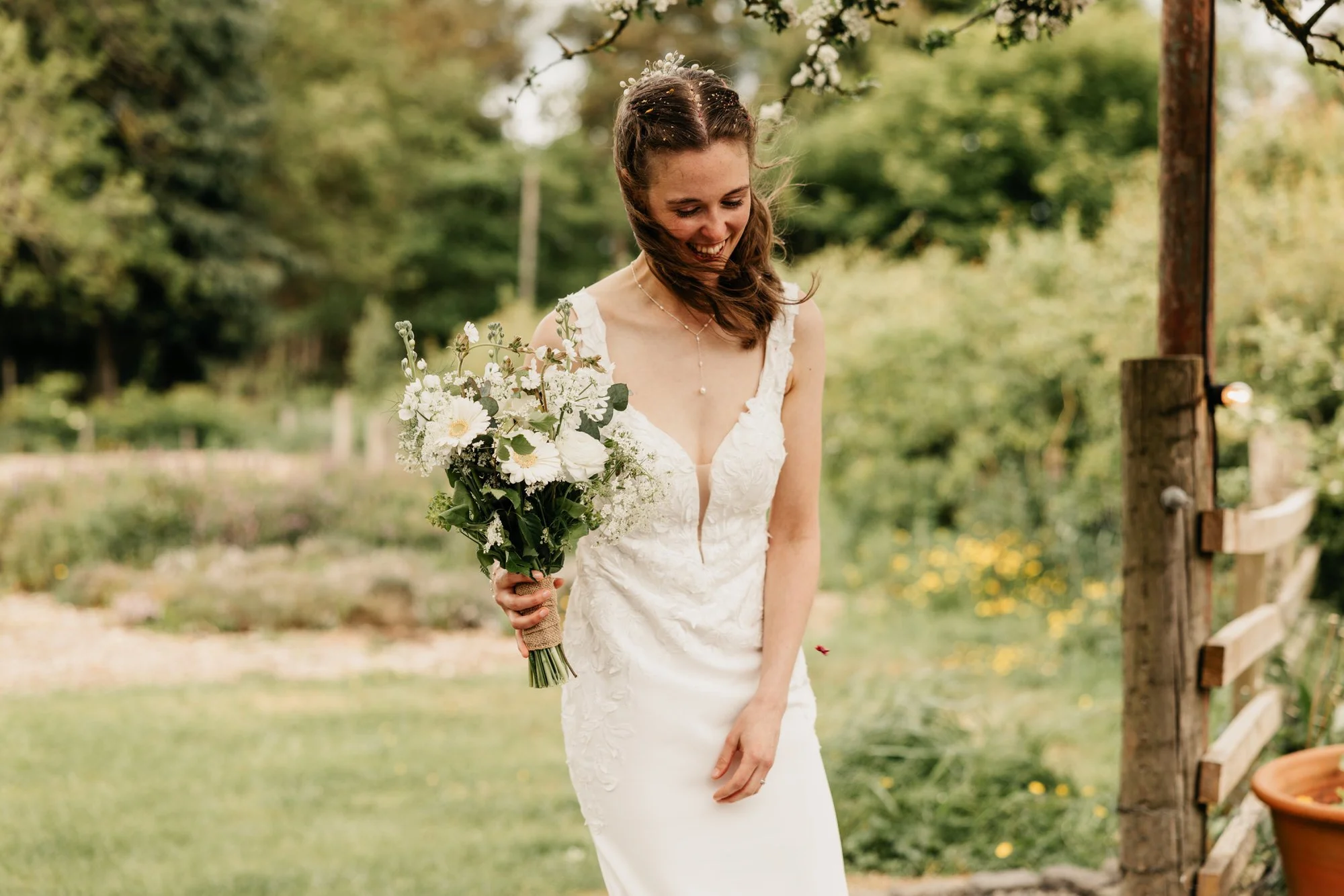 A bride holding her bouquet in the garden
