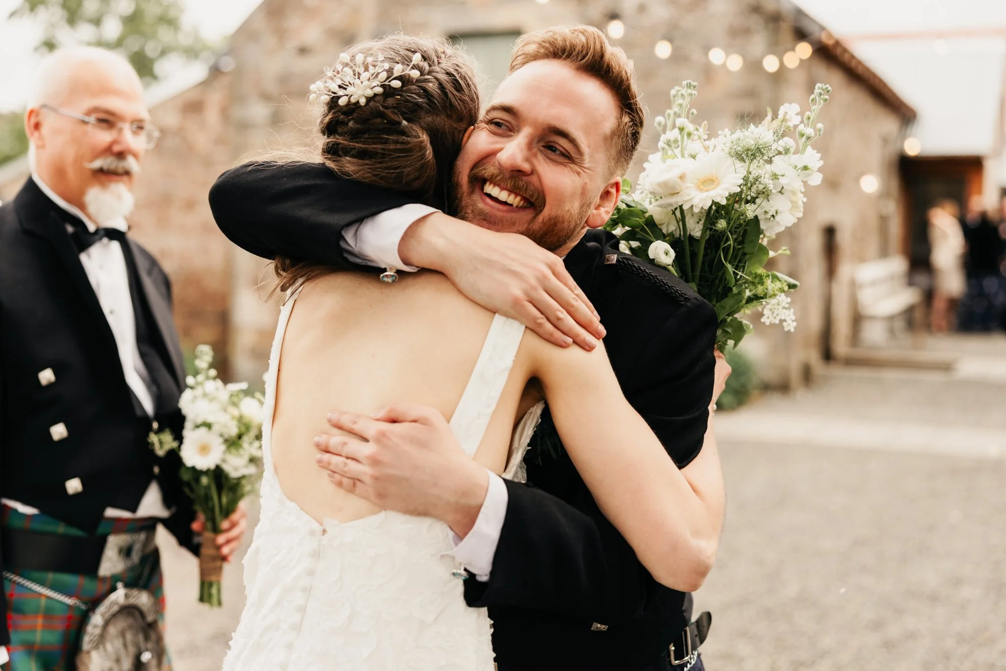 A laughing embrace after the wedding ceremony