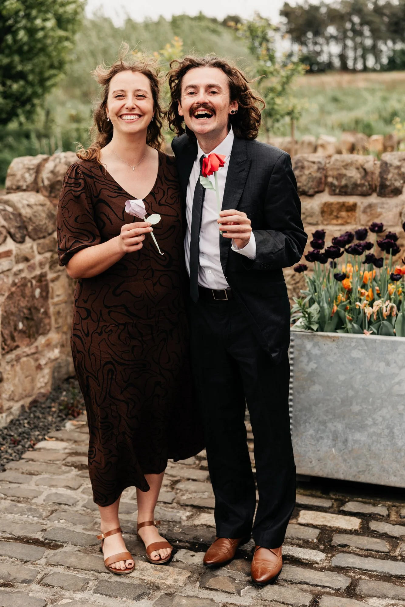 Two guests enjoying drinks outside