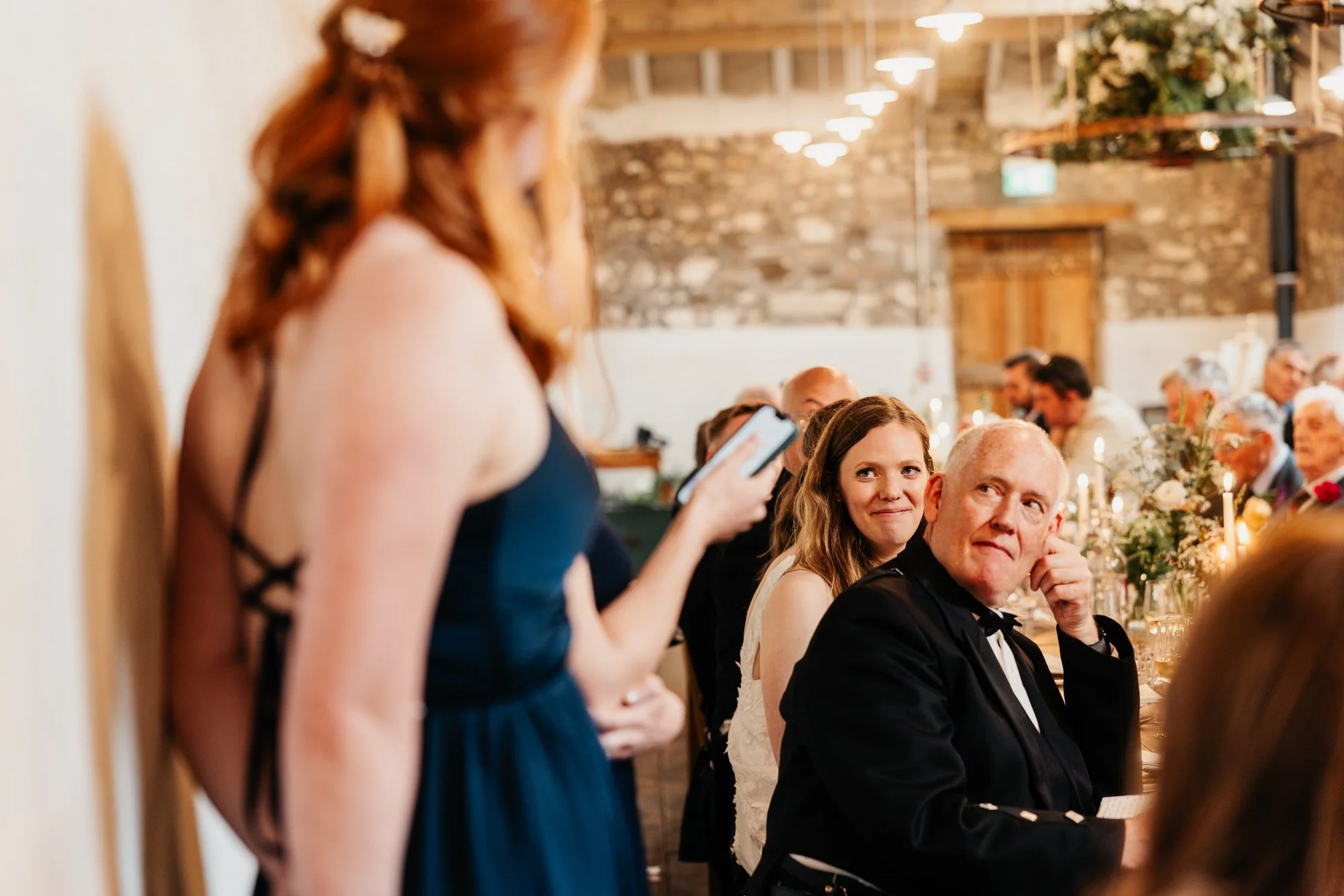 A seated guest listening to a speech