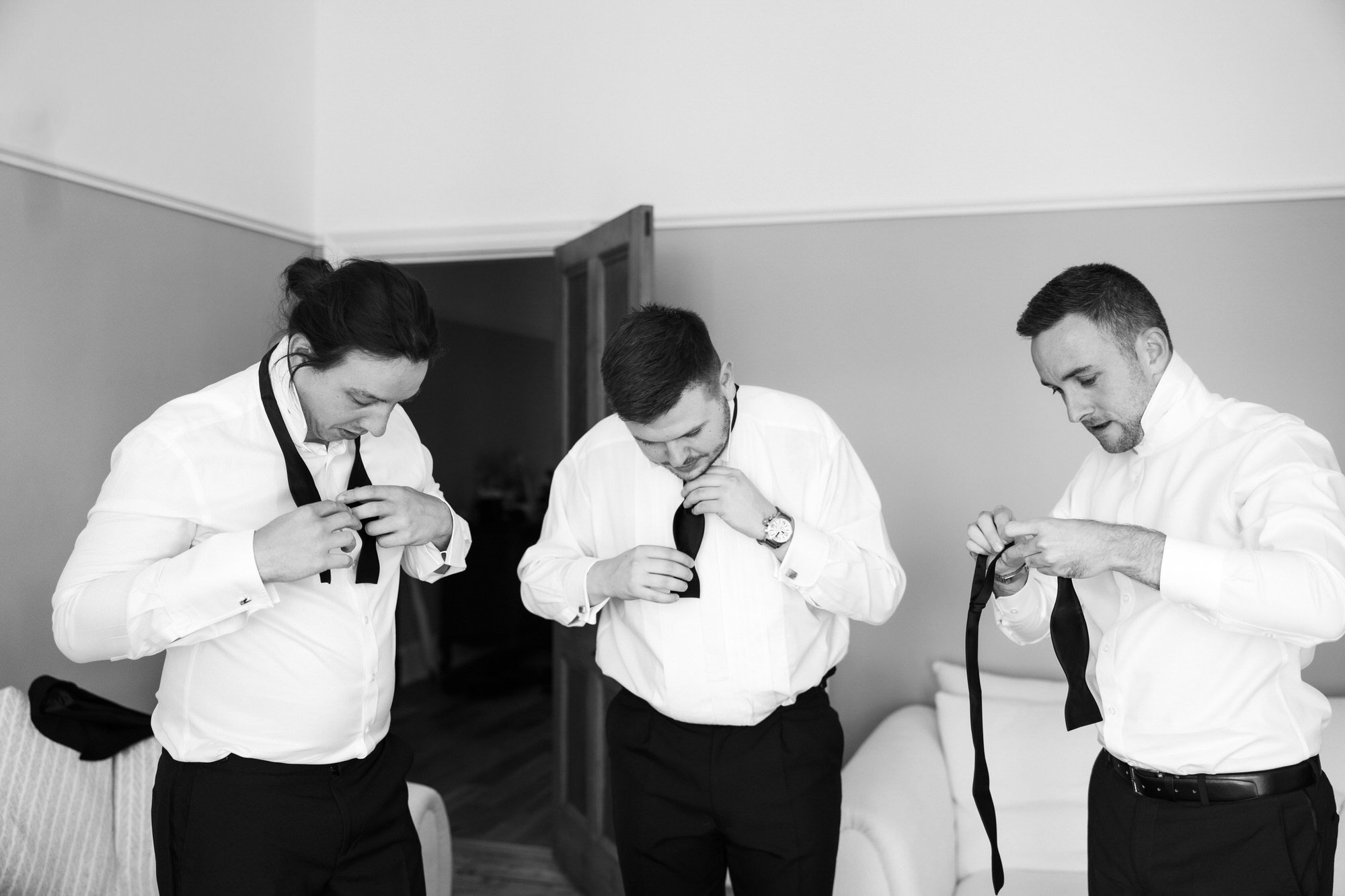 Jonathan and his groomsmen adjusting their bow ties