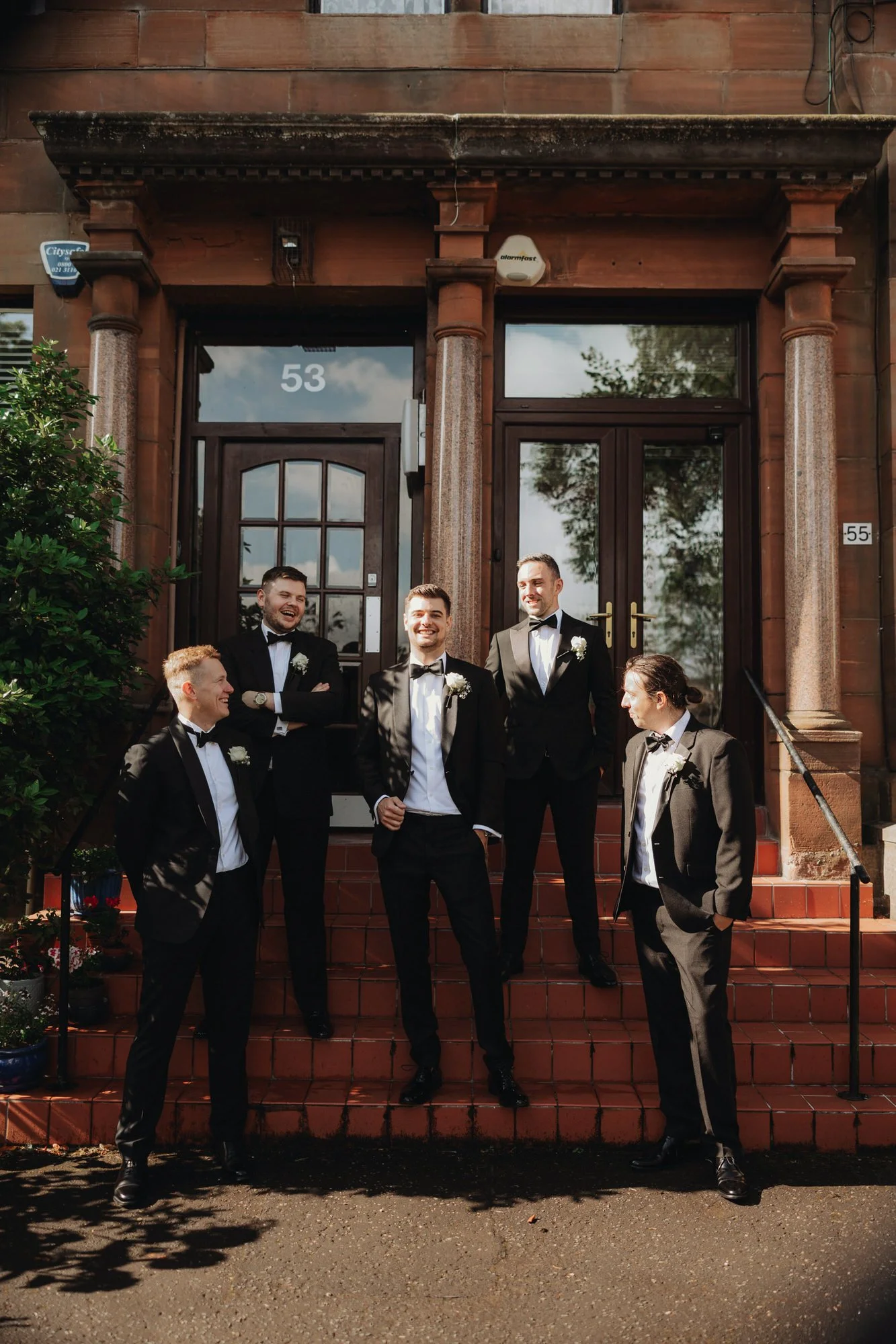 The groom and groomsmen outside the Glasgow flat