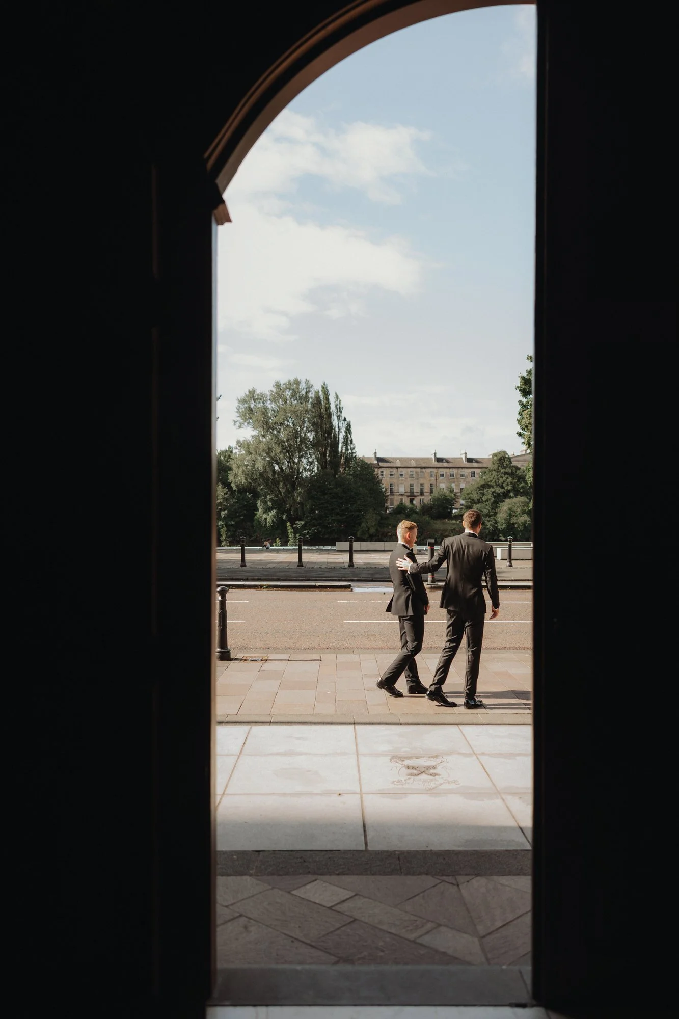 Wedding guests approaching the cathedral through its doorway