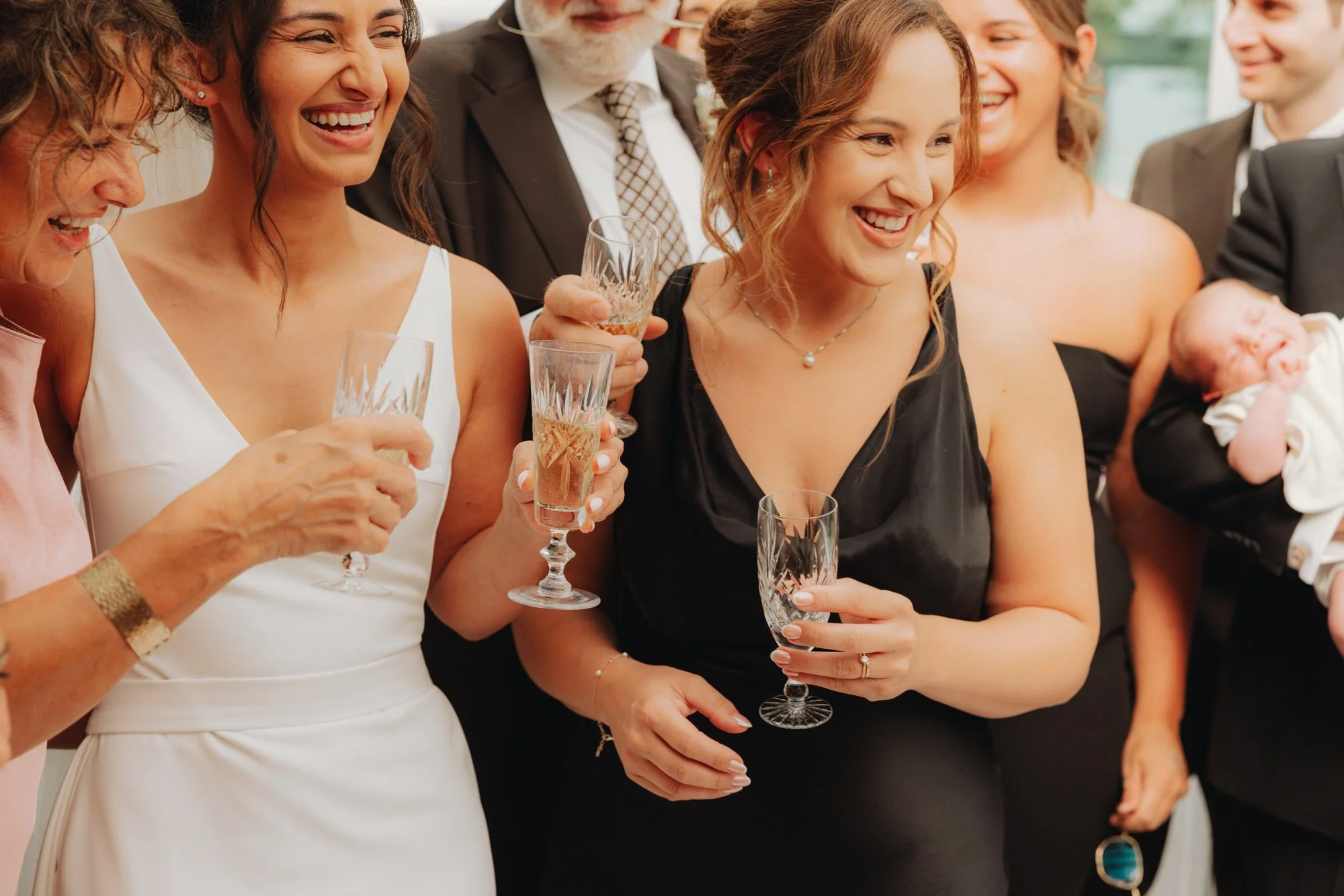 Caterina and a bridesmaid laughing with drinks