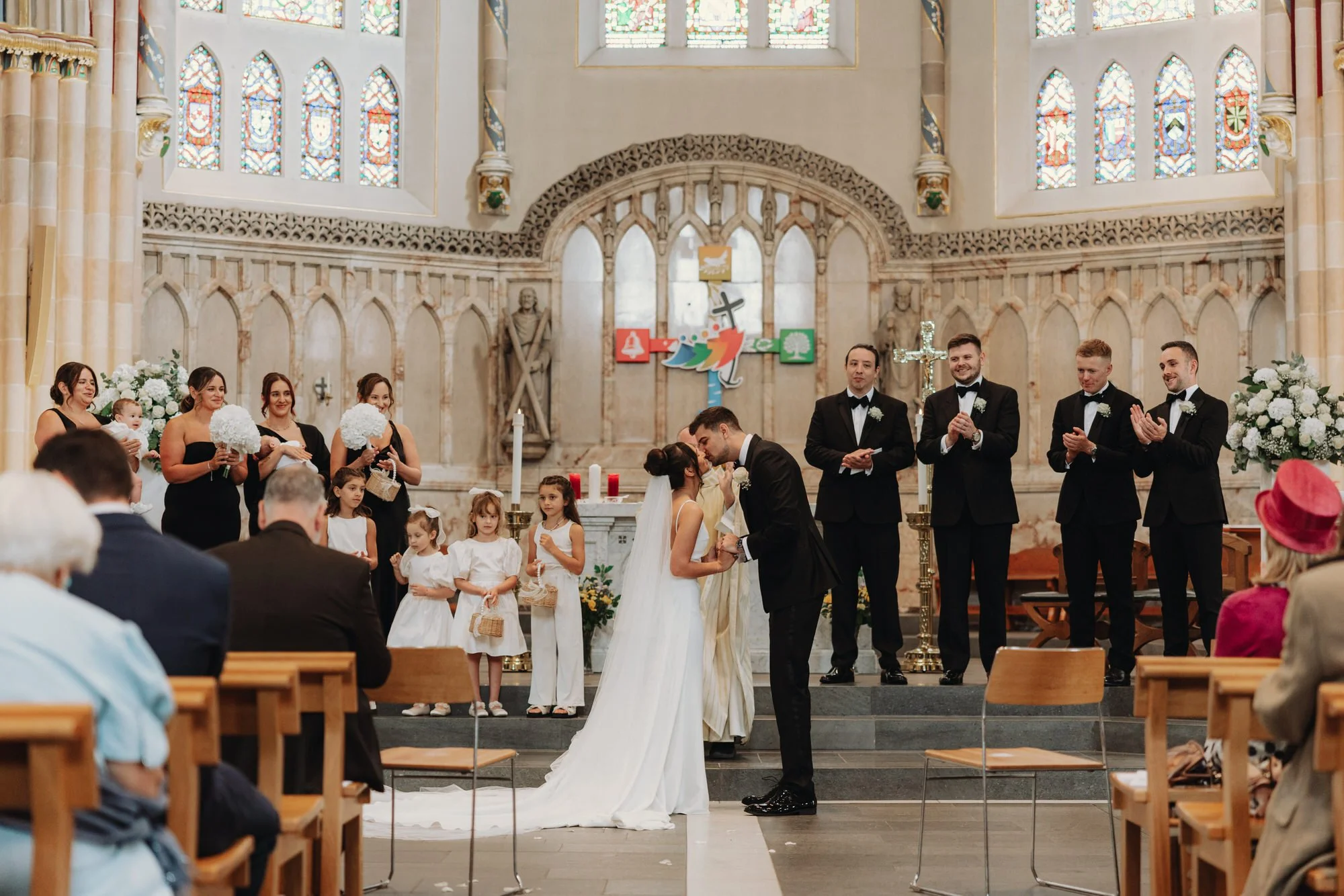 The couple and wedding party at the cathedral altar