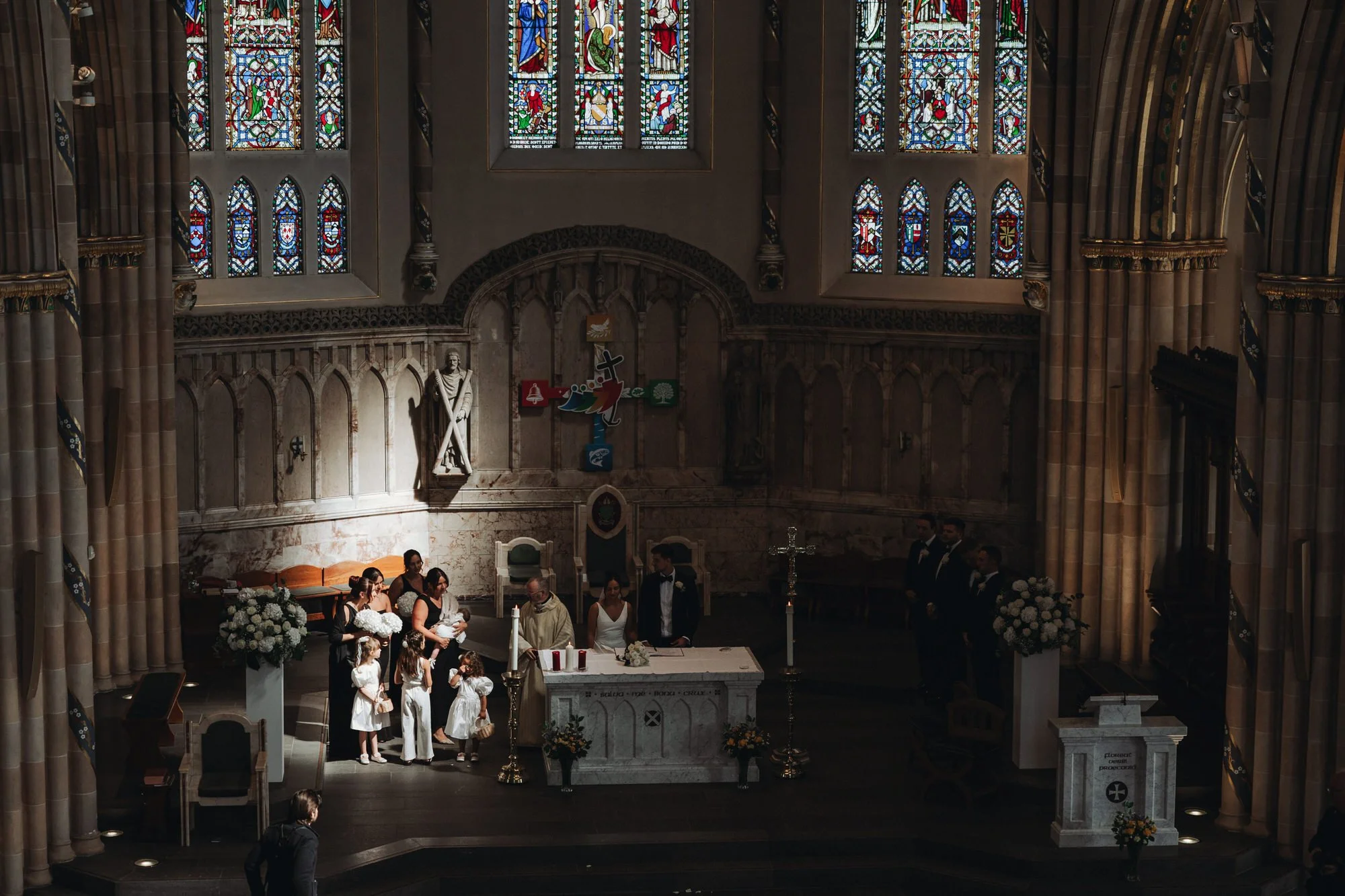 Light falling across the wedding ceremony inside the cathedral