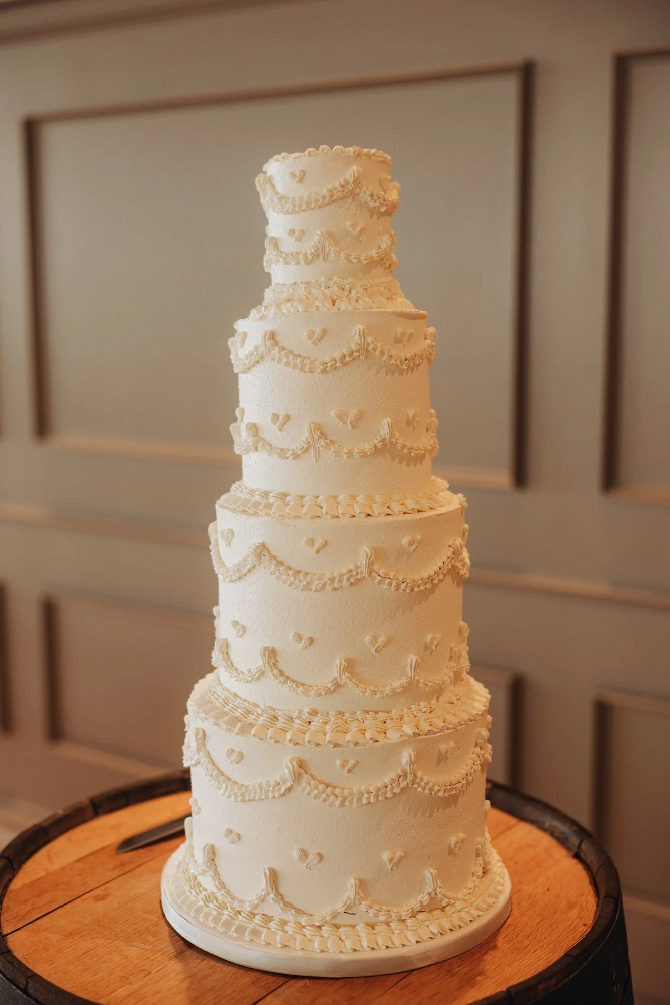 Tiered white wedding cake from The Honeybee Bakery