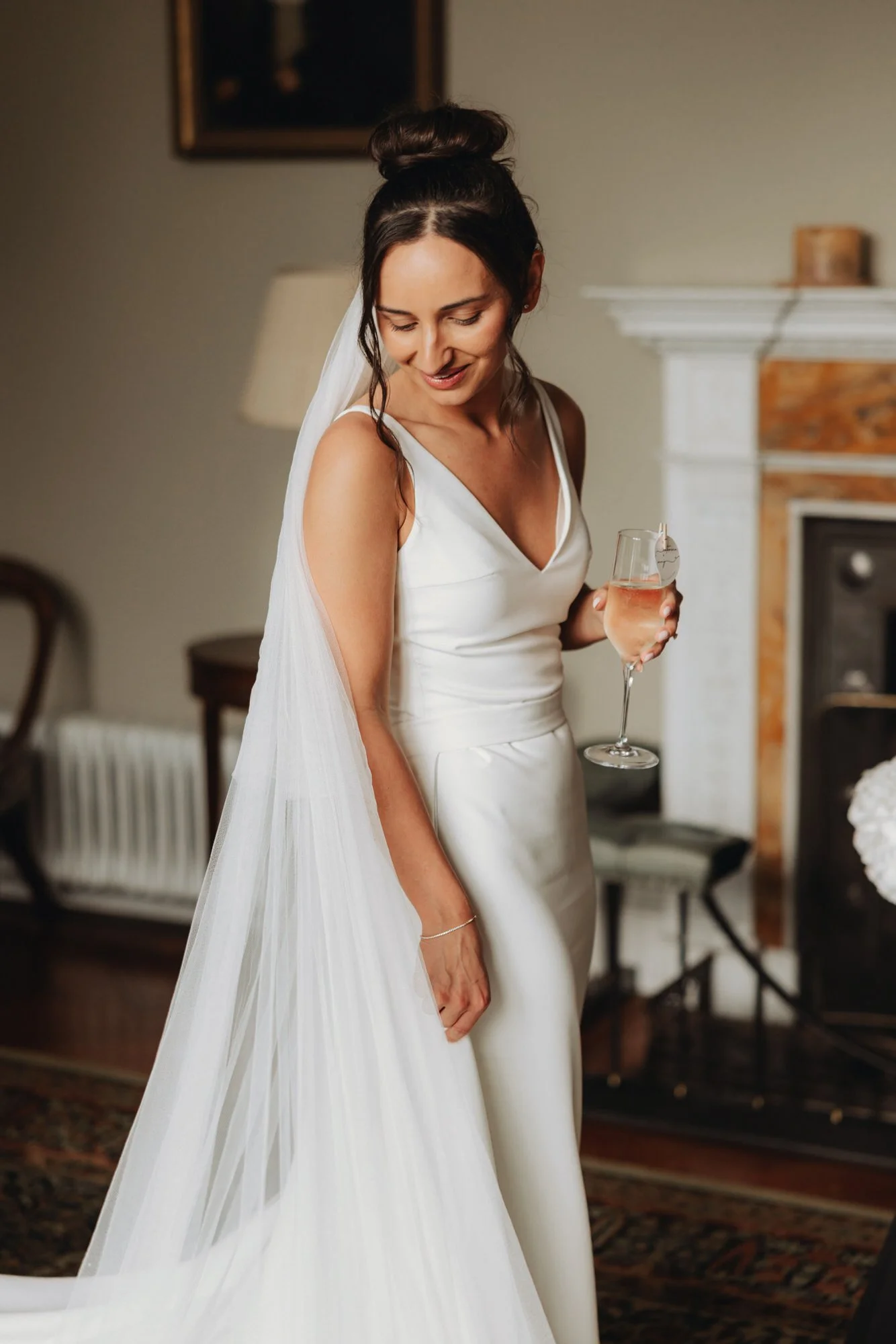 Caterina holding a glass in the castle drawing room