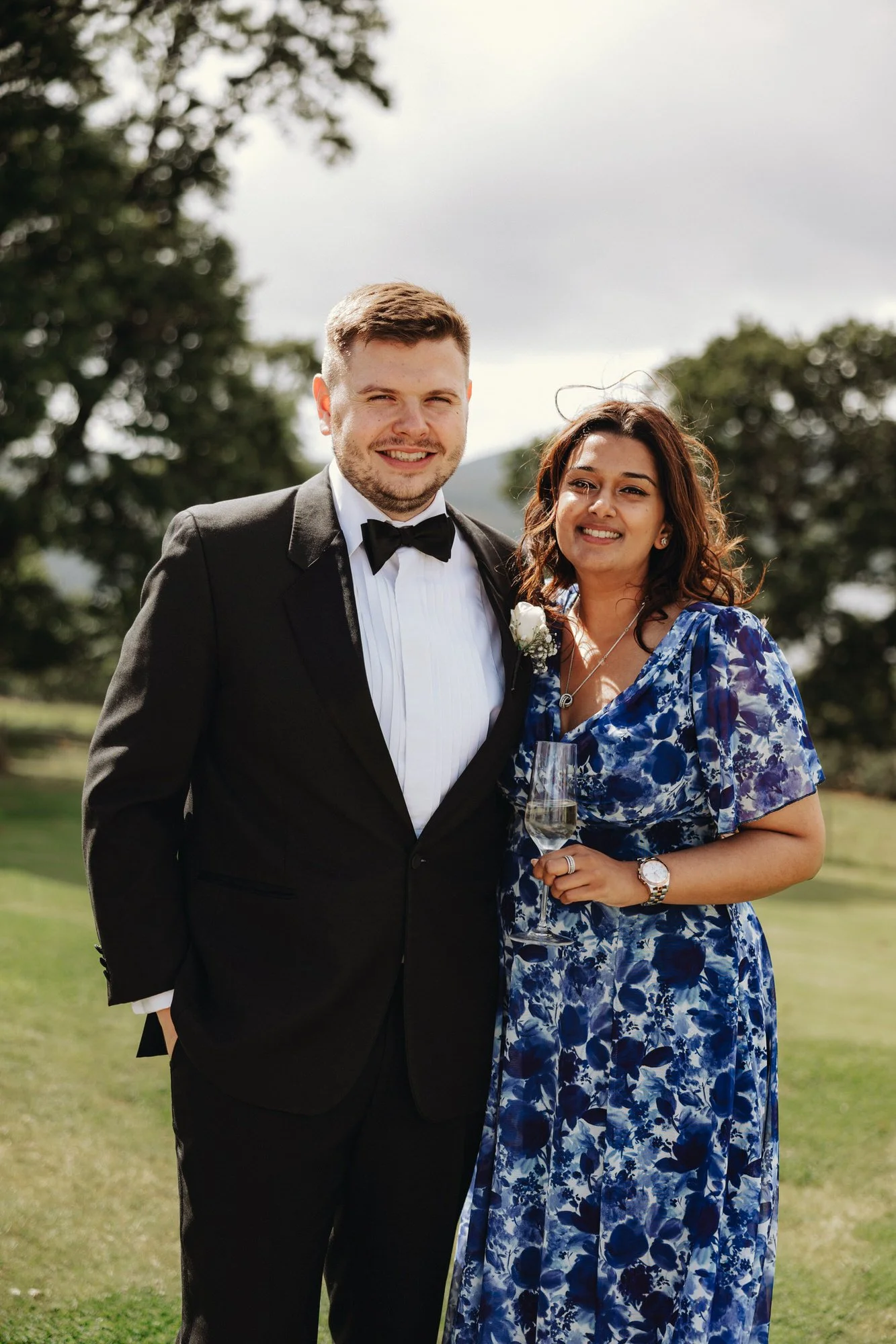 Jonathan standing with a wedding guest in the grounds