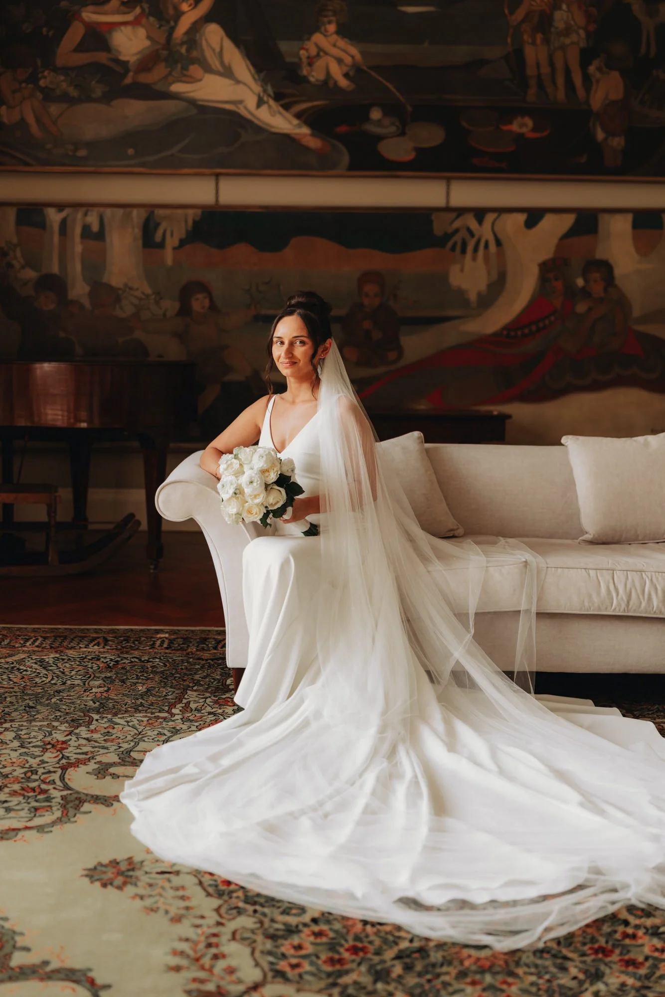 Caterina seated beneath a painting in the castle