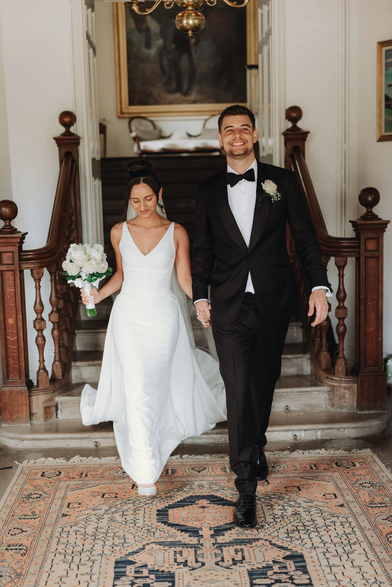 Caterina and Jonathan walking down the castle staircase