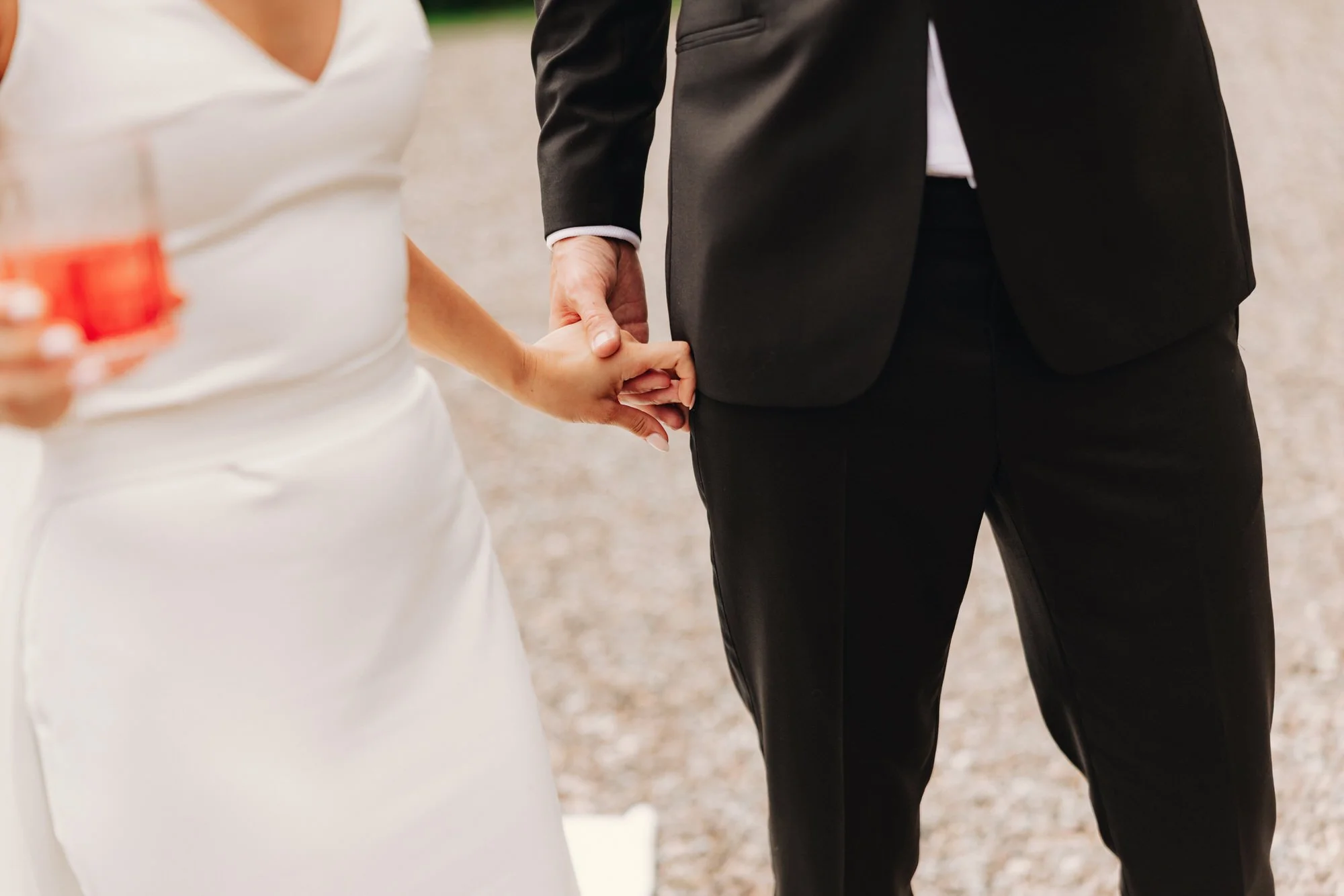 Caterina and Jonathan holding hands during the reception