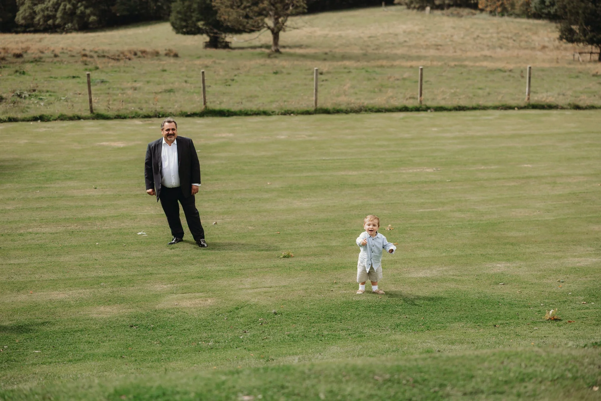 A small child running across the castle lawn